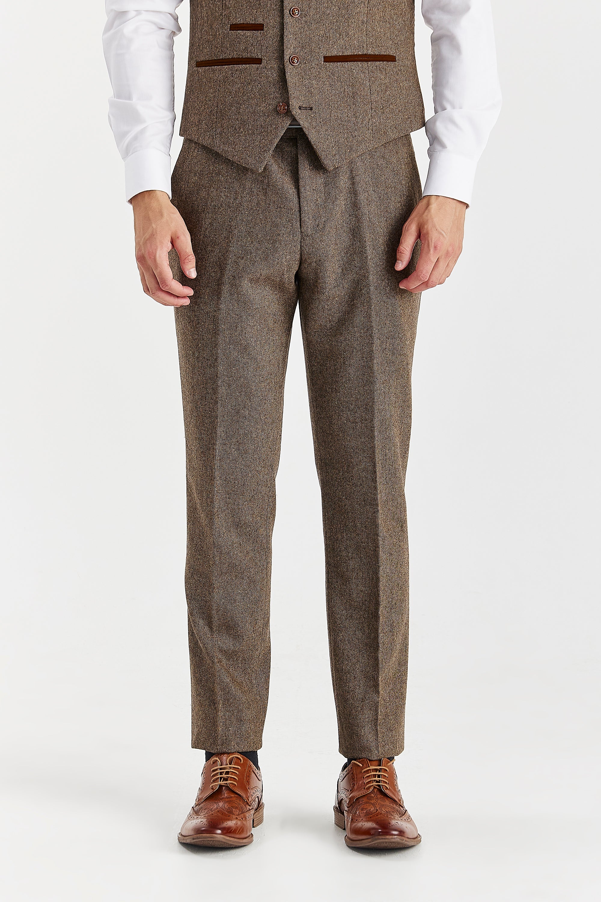 Men’s brown tweed trousers shown from the front, worn with the matching waistcoat, white shirt and brown brogues.