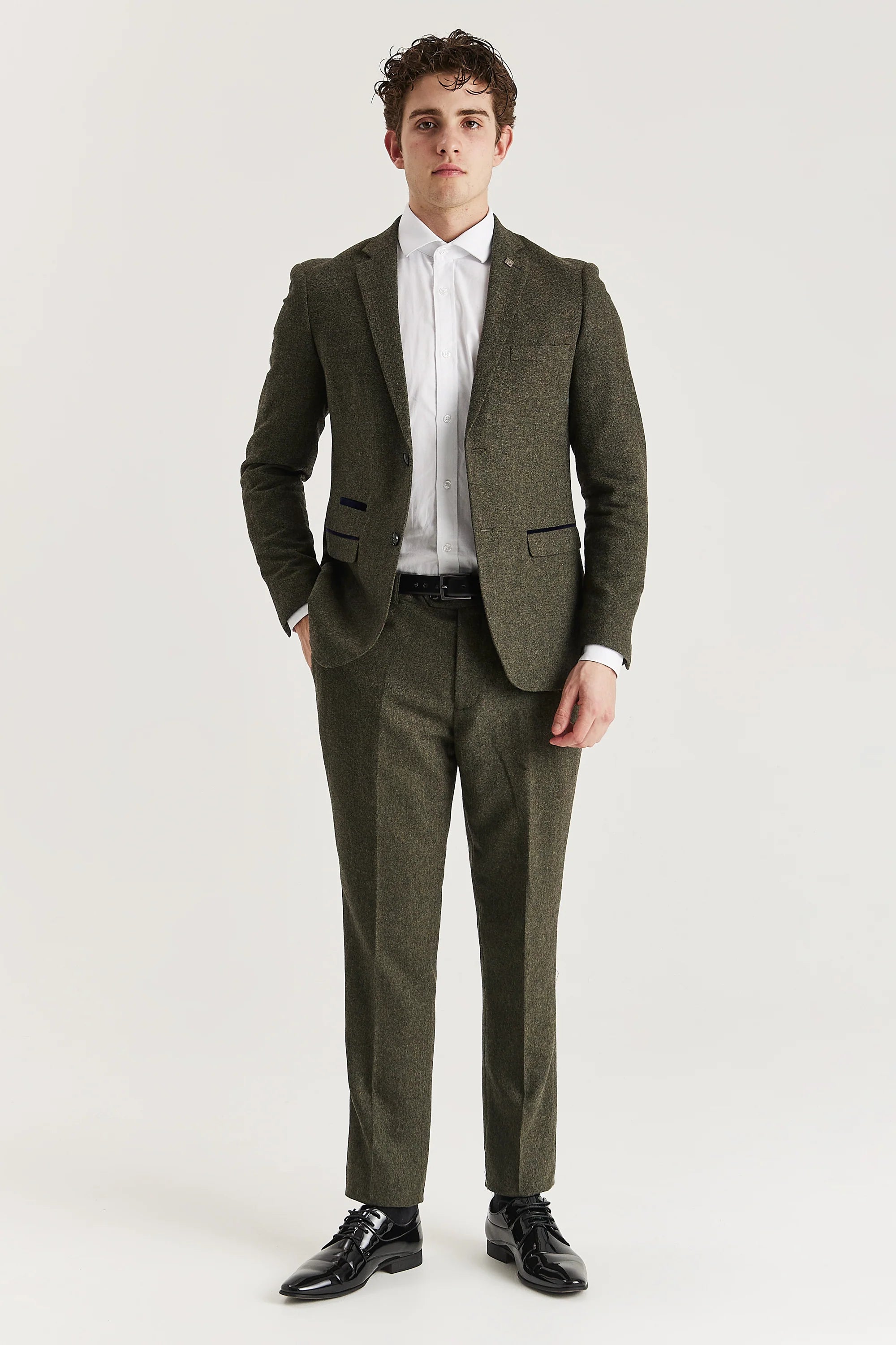 Men’s green tweed trousers shown as part of a full outfit with the matching blazer and a white shirt.