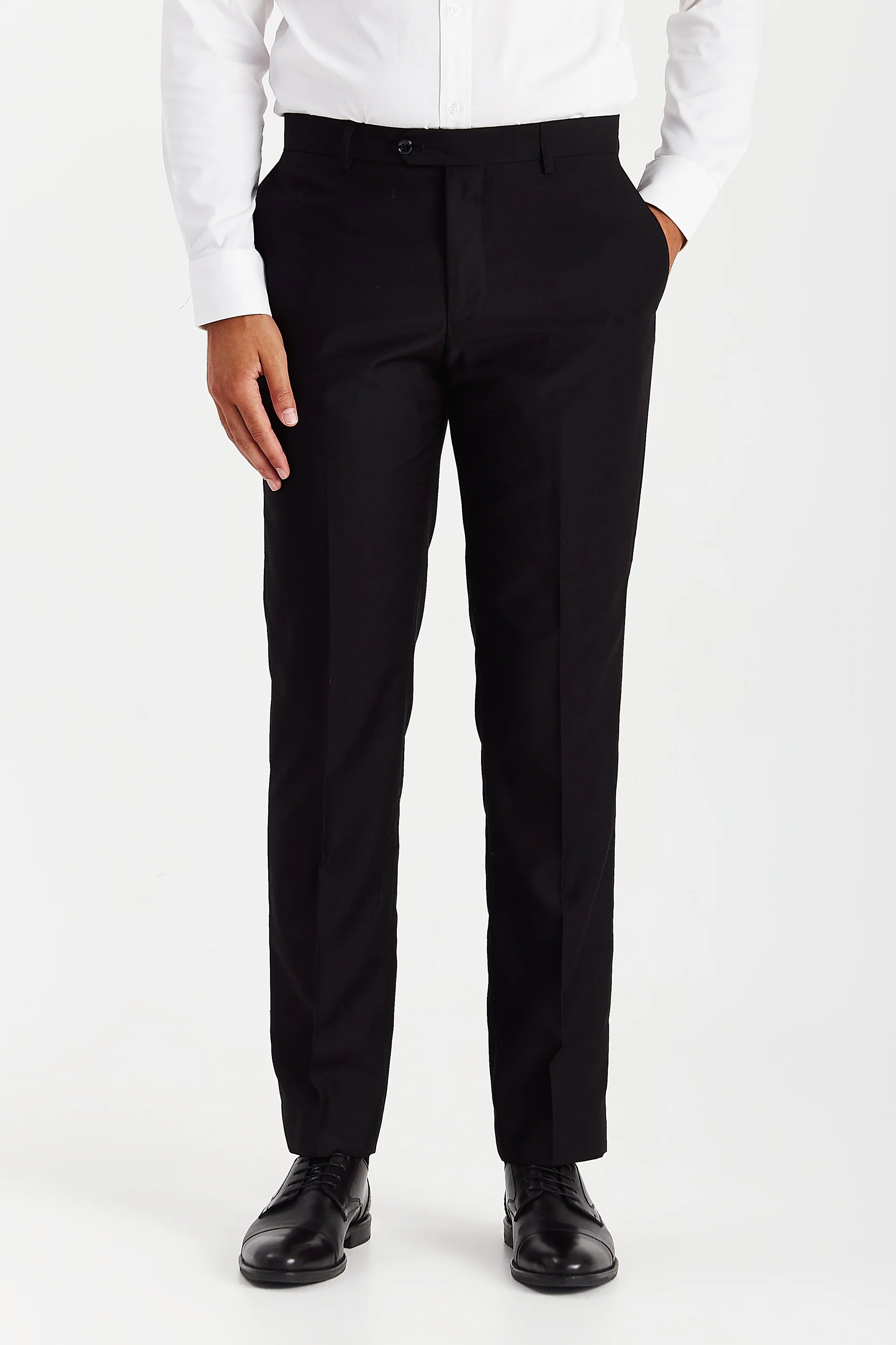 Men’s black trousers shown from the front, worn with a white shirt and black formal shoes.