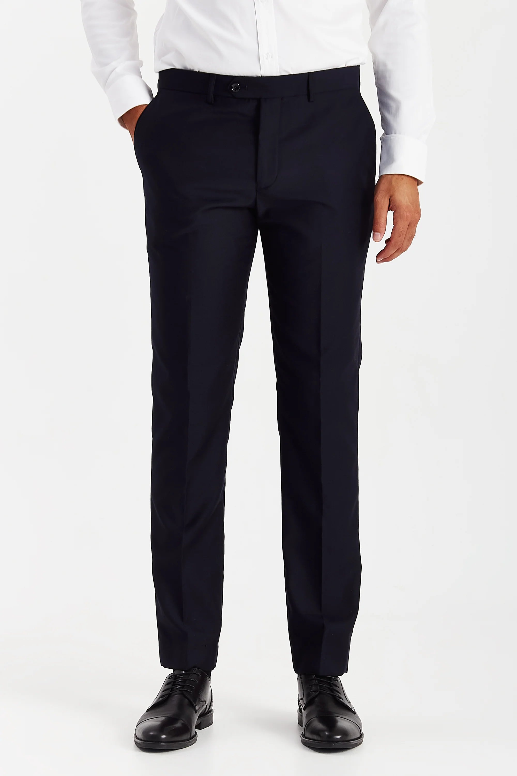 Men’s navy trousers shown from the front, worn with a white shirt and black formal shoes.