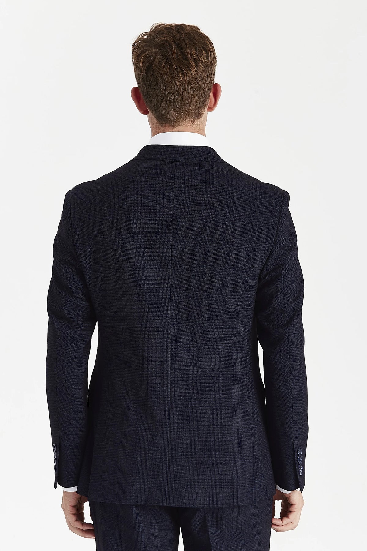 Back of the navy check jacket, showing a shaped waist, centre seam, twin side vents and four buttons on each cuff.