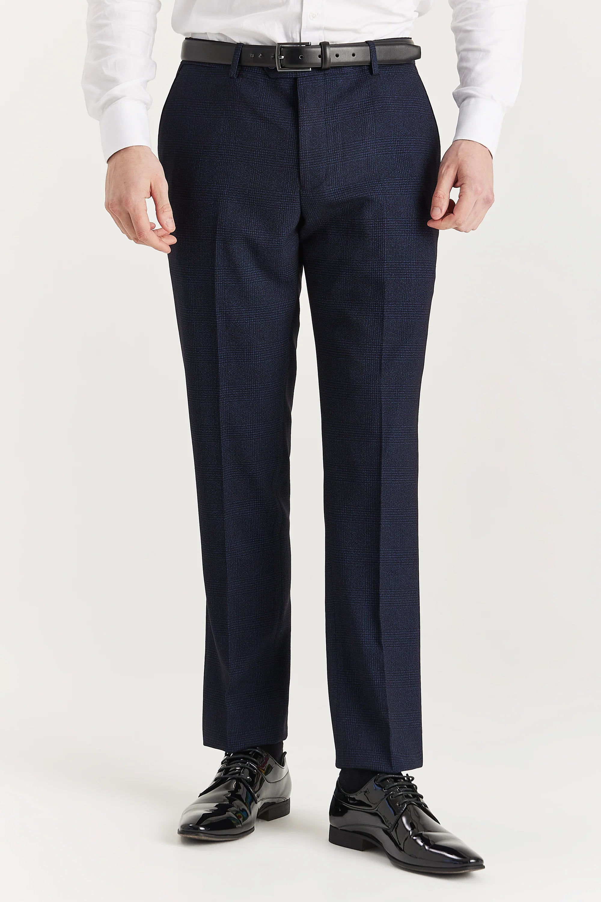 Men’s navy check trousers shown from the front, worn with a white shirt and black formal shoes.