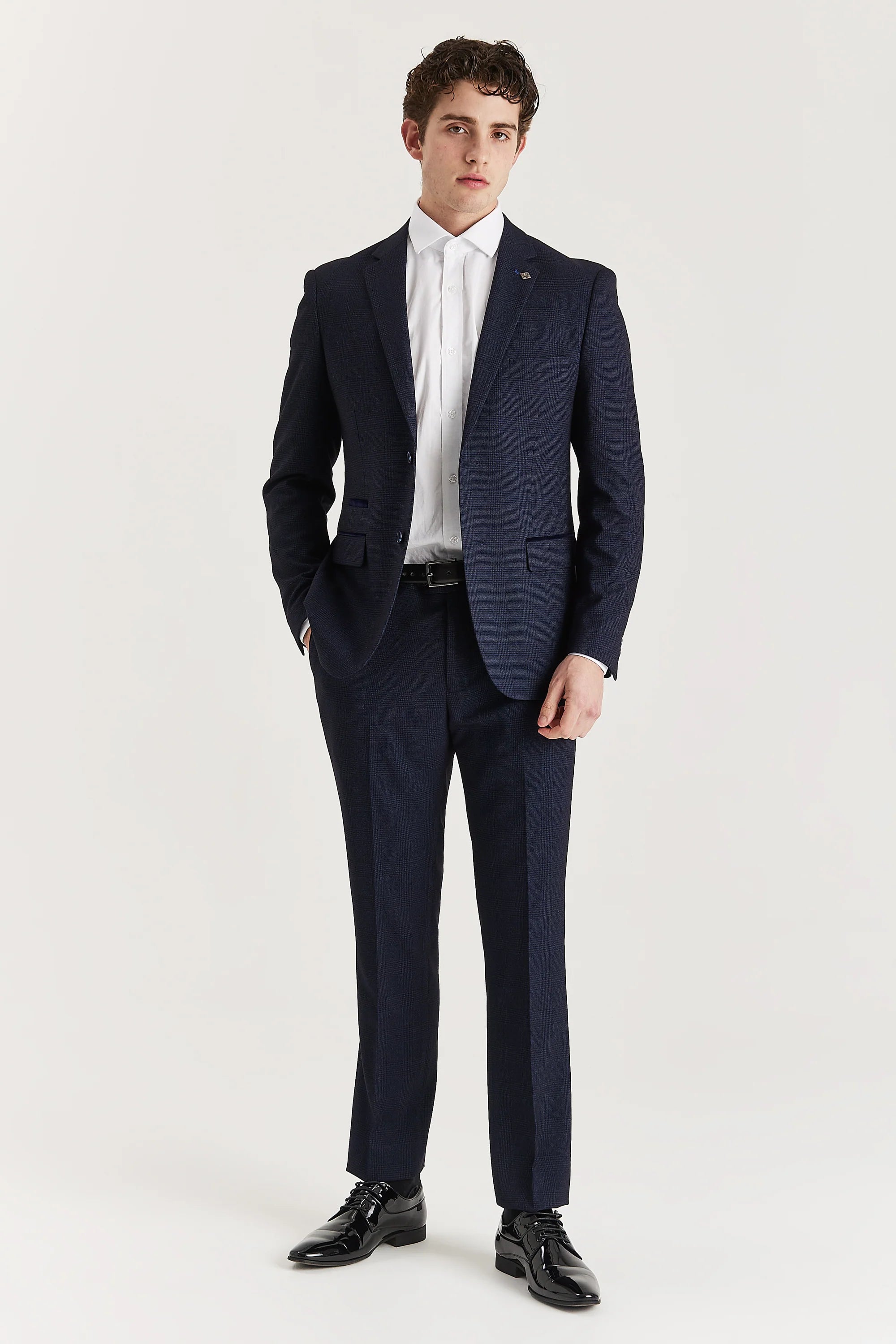 Men’s navy check trousers shown as part of a full outfit with the matching blazer and a white shirt.