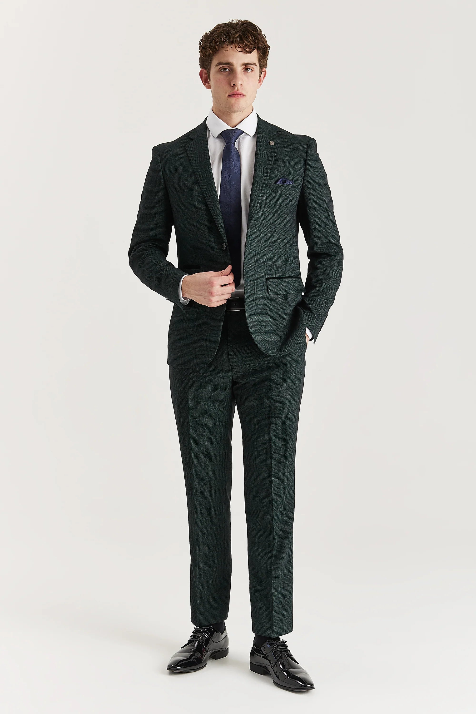 Men’s olive check trousers shown as part of a full outfit with the matching blazer, white shirt and blue tie.