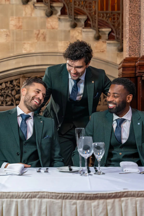 Paul Andrew Regent olive check three piece suit worn by three male models at a formal dining table