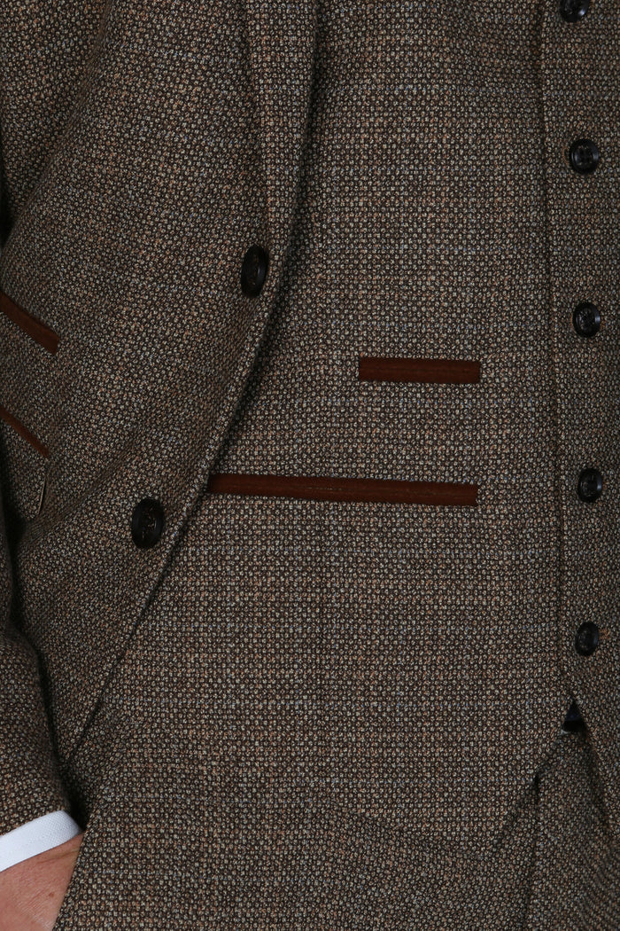 Close-up of the Paul Andrew Ralph brown tweed blazer pocket showing rich texture and brown suede trim detailing