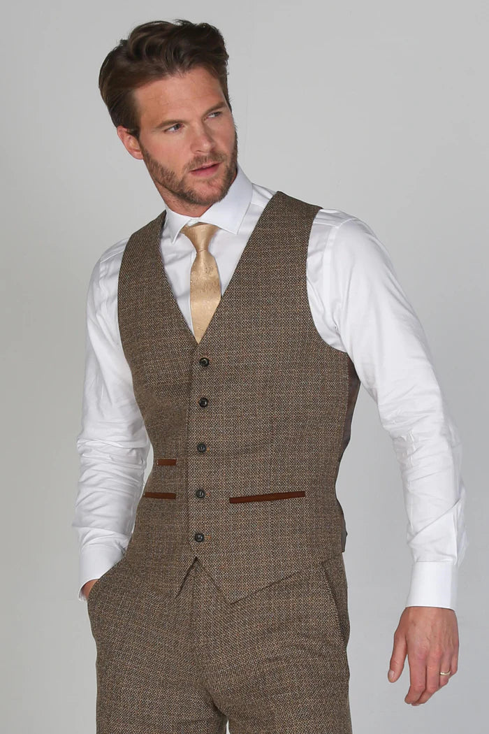 Front view of brown tweed waistcoat paired with white shirt and gold tie