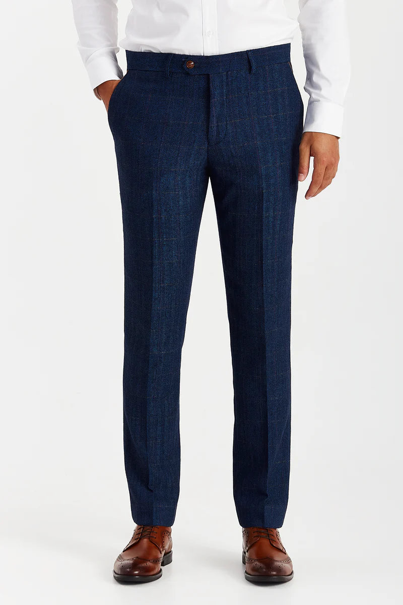 full front view of the navy tweed check trousers with a pressed crease, worn with a white shirt and tan brogues to show the fit and leg shape