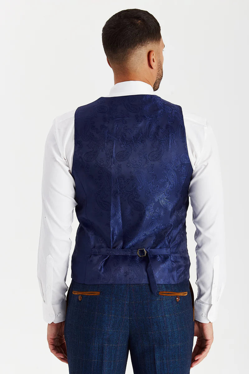 back view of the waistcoat showing the navy paisley satin lining and adjustable strap for a tailored fit, paired with matching navy tweed trousers