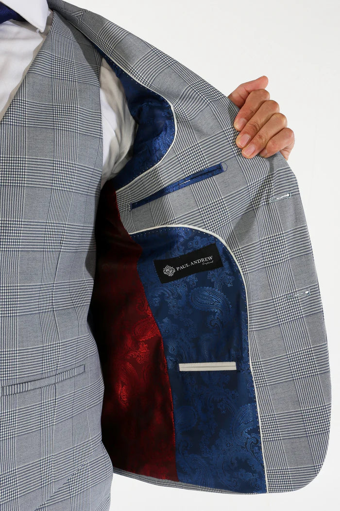 Close-up of the interior of the sky blue blazer, showcasing paisley red and blue lining with Paul Andrew branding.
