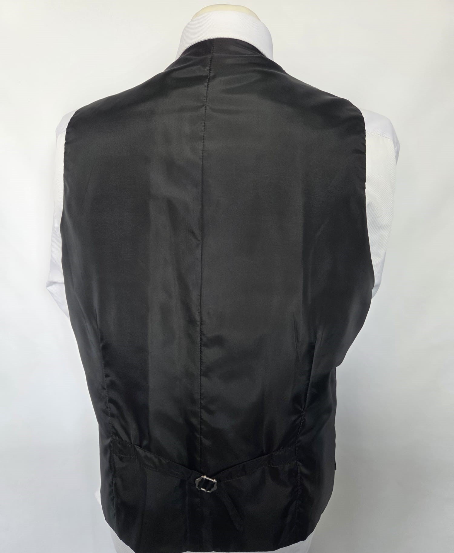 Back of black waistcoat with satin finish and adjustable belt.
