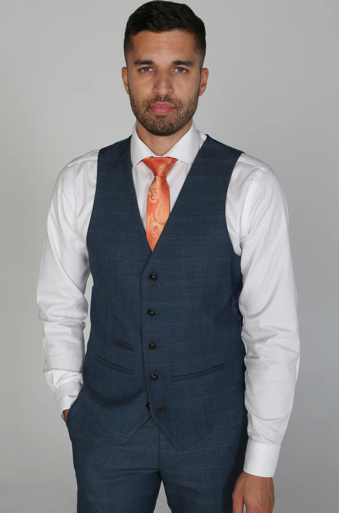 Man wearing the front of the Viceroy navy waistcoat with white shirt and bold orange paisley tie.