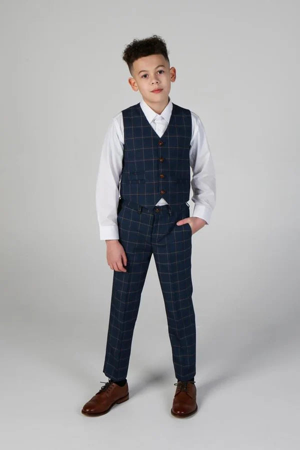 Young boy in navy windowpane waistcoat and matching trousers with hand in pocket.