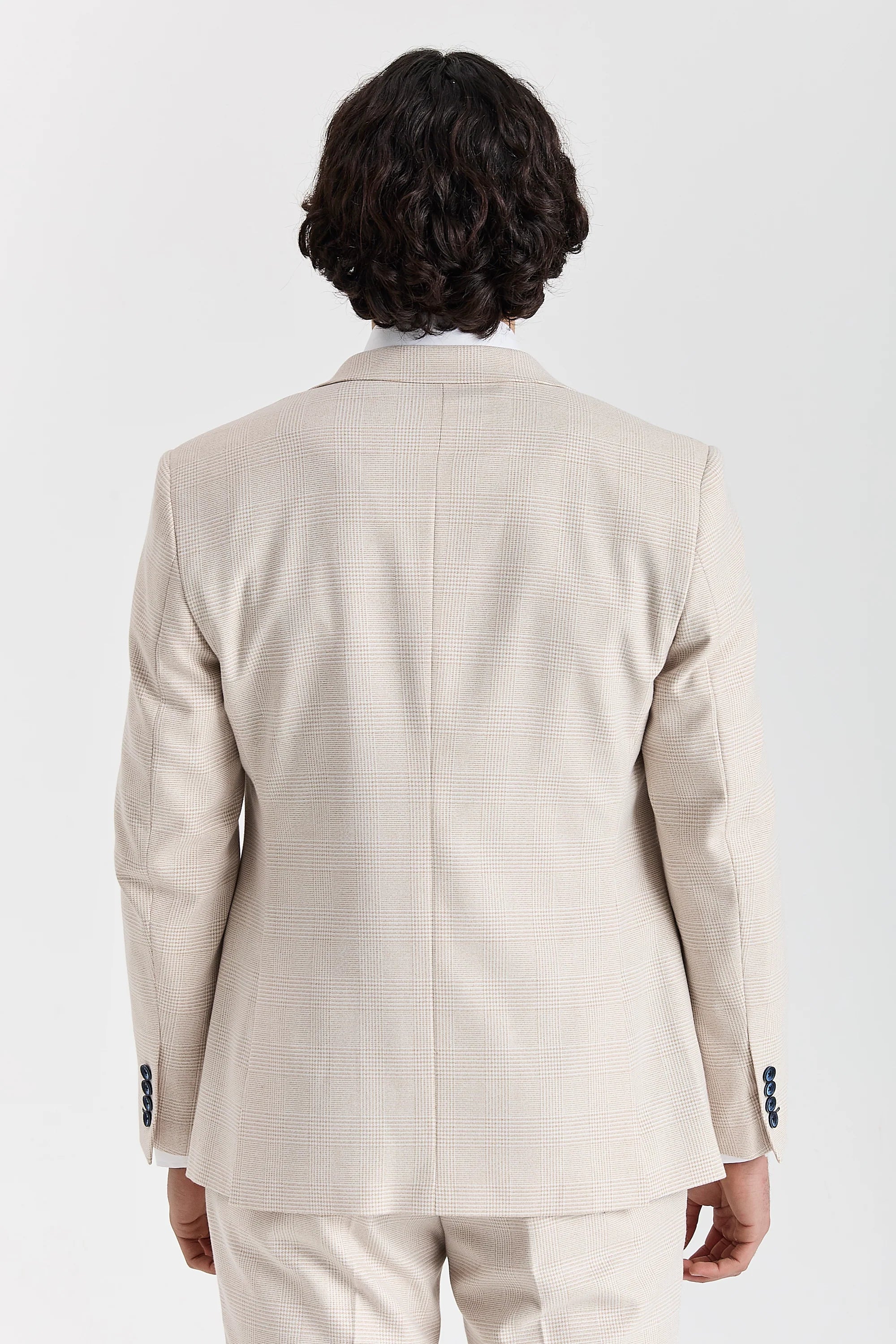 Rear view of the cream glen check blazer with a vent less back, central back seam and navy sleeve buttons.