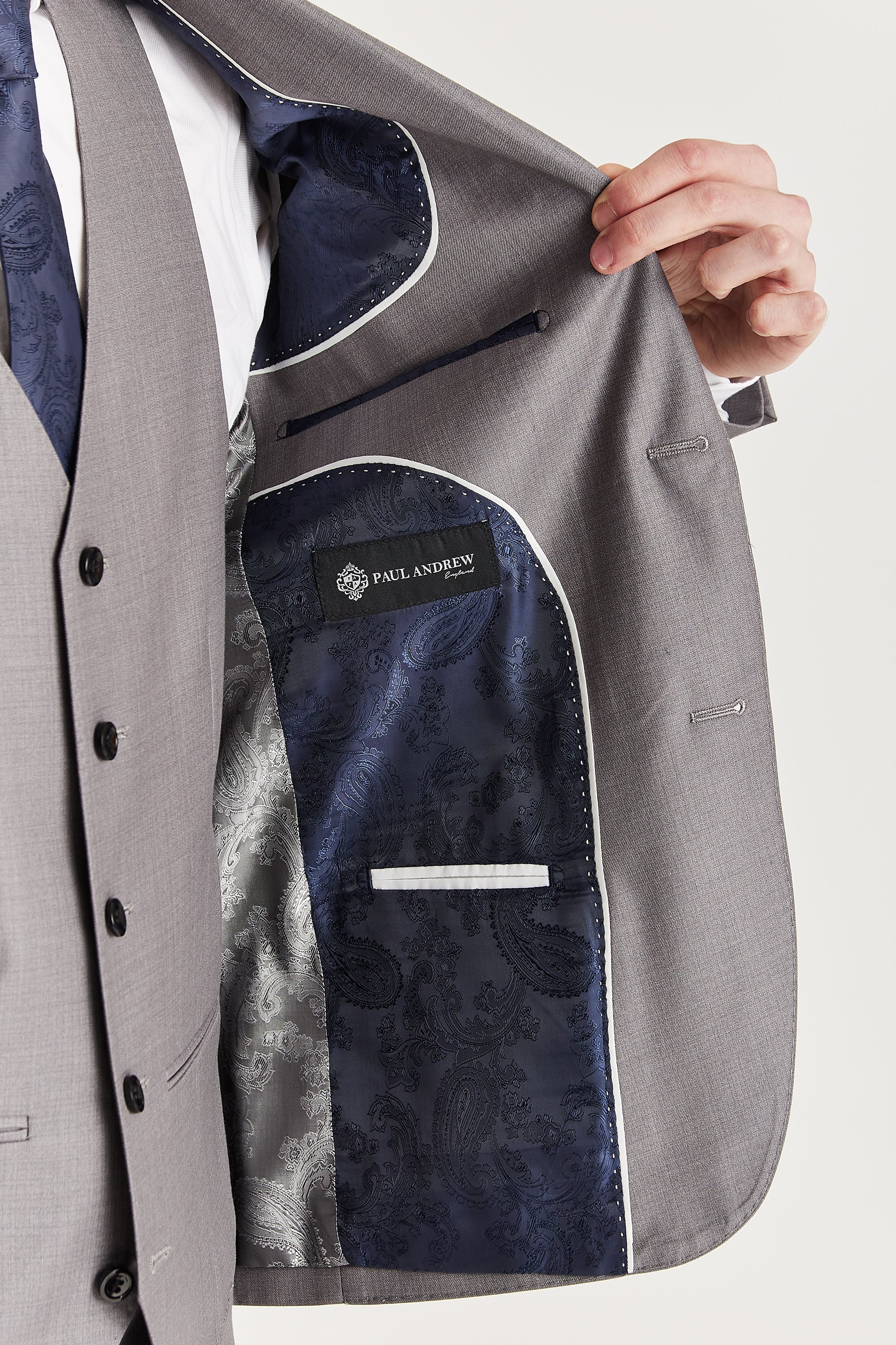 Interior view of the grey blazer with navy and silver paisley lining and a visible Paul Andrew logo label.