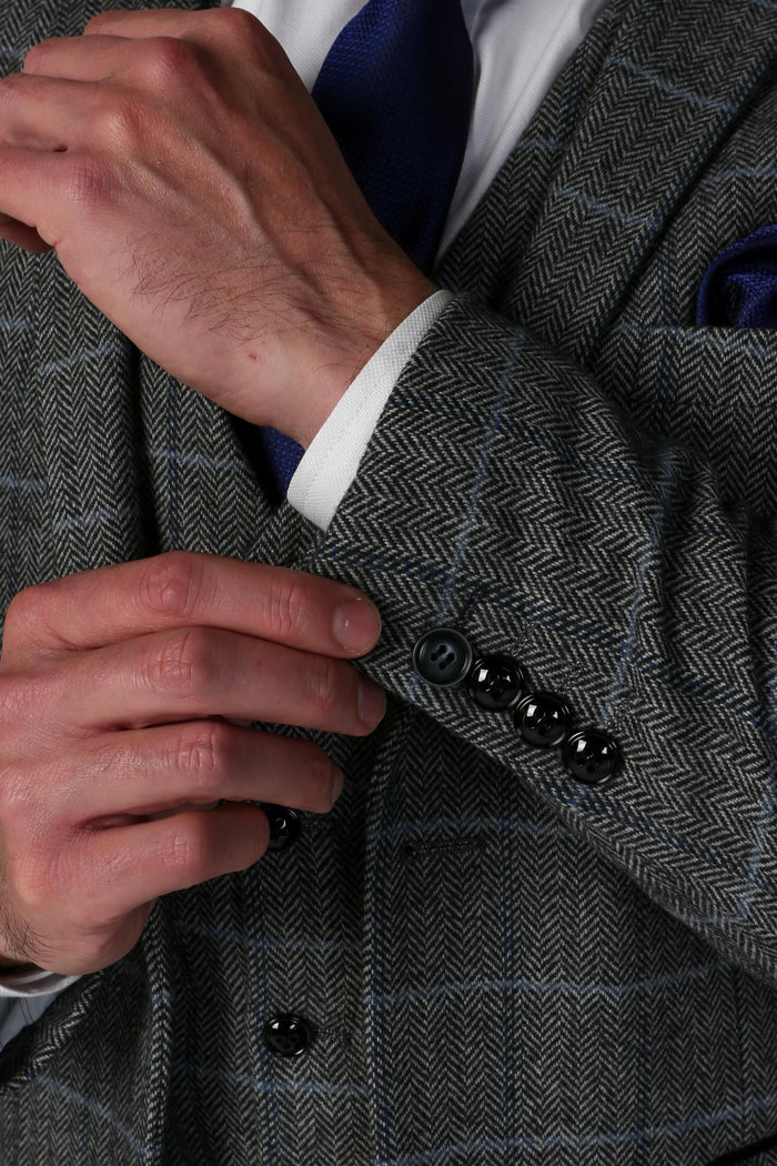 Close-up of the Harris Grey Tweed Check suit sleeve detailing, featuring stylish black buttons and intricate fabric pattern.