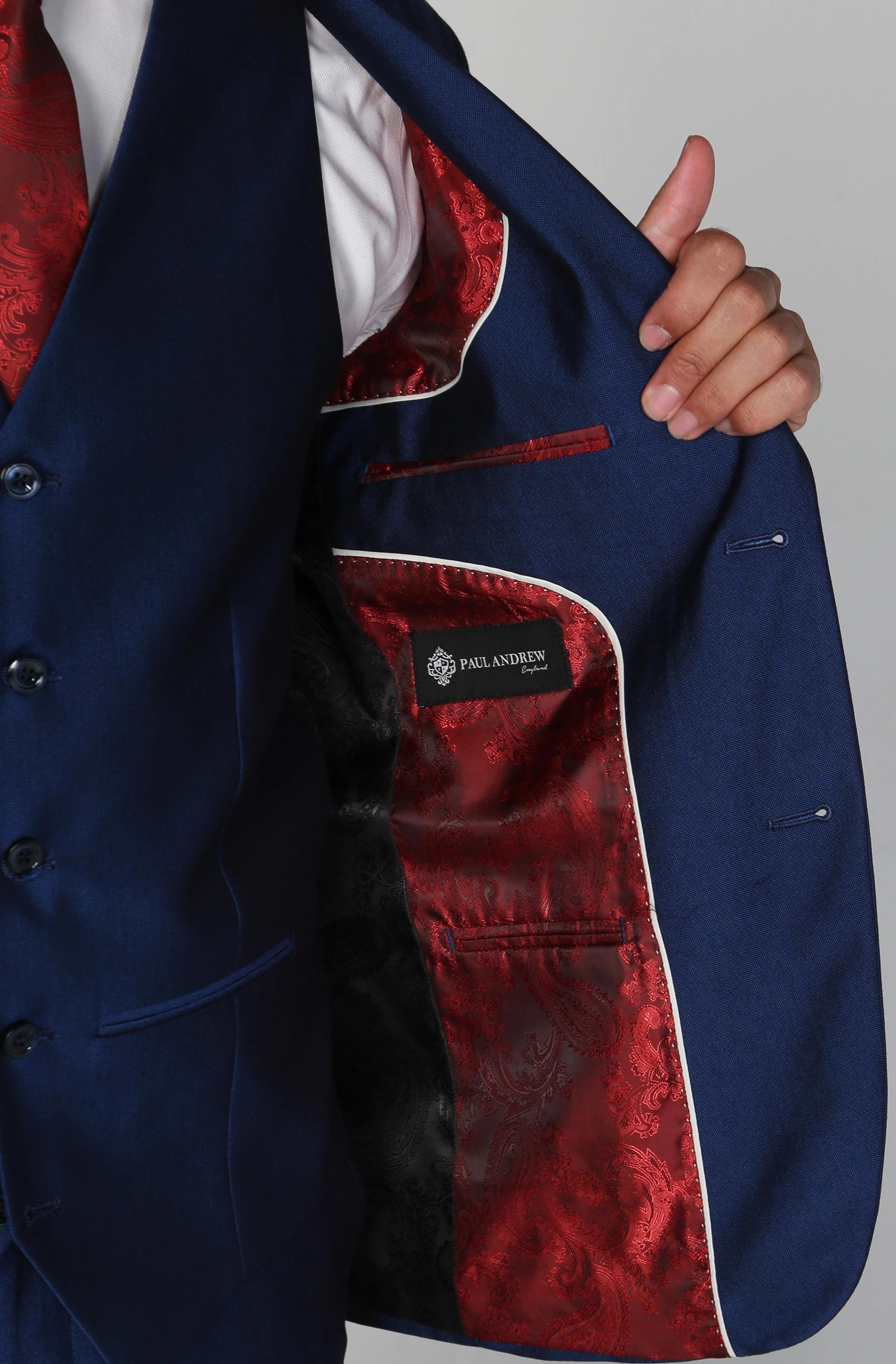 Interior view of the Kingsley Blue Men's three-piece suit jacket, showcasing the red and black paisley lining.
