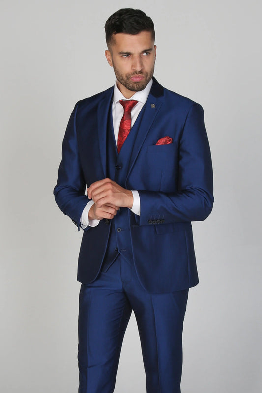 Kingsley Blue Men's three-piece suit with a white dress shirt and red tie, model posing with hands clasped.