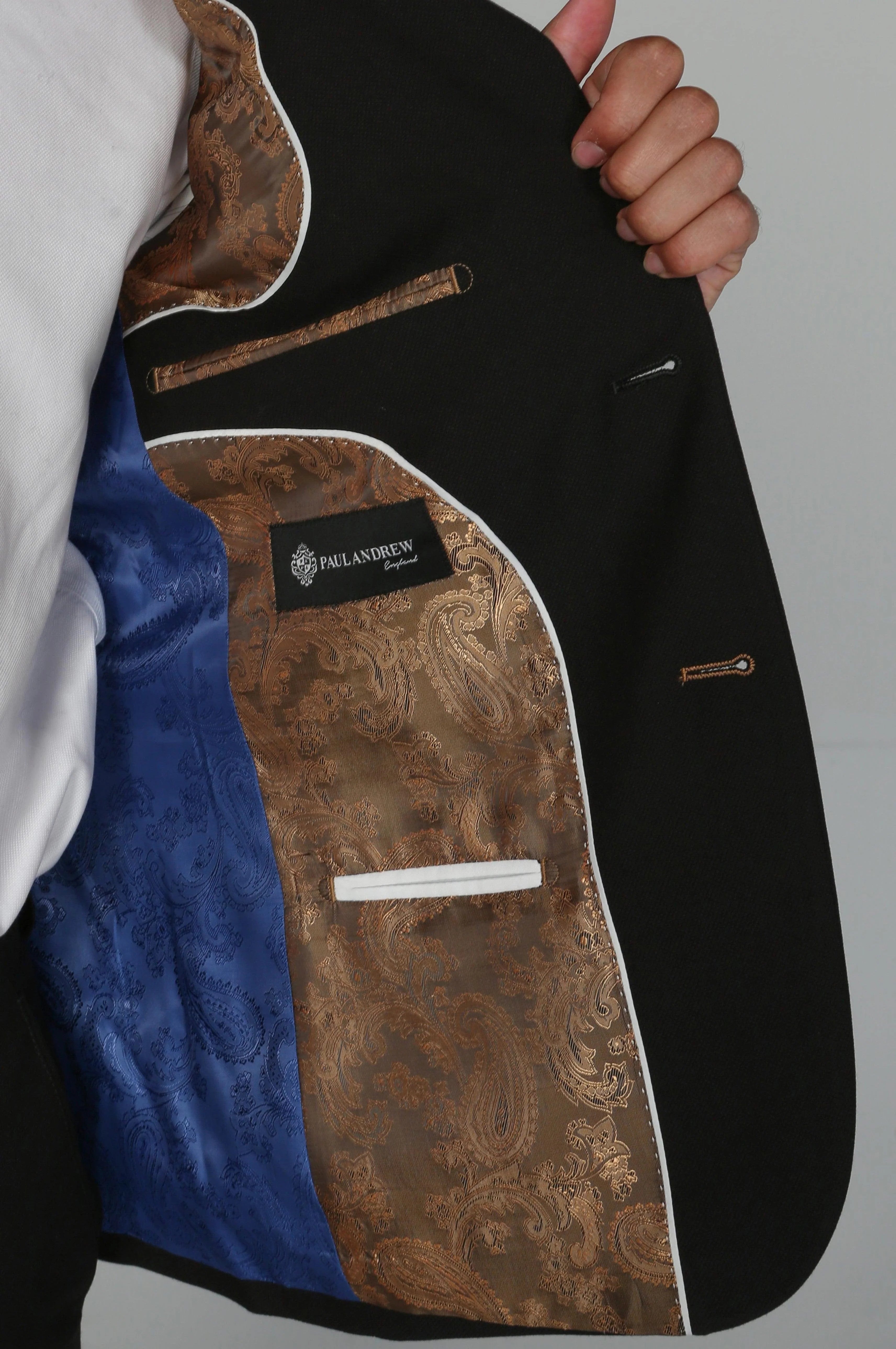  Inside view of the Mayfair black suit jacket showing its bronze and blue paisley lining.