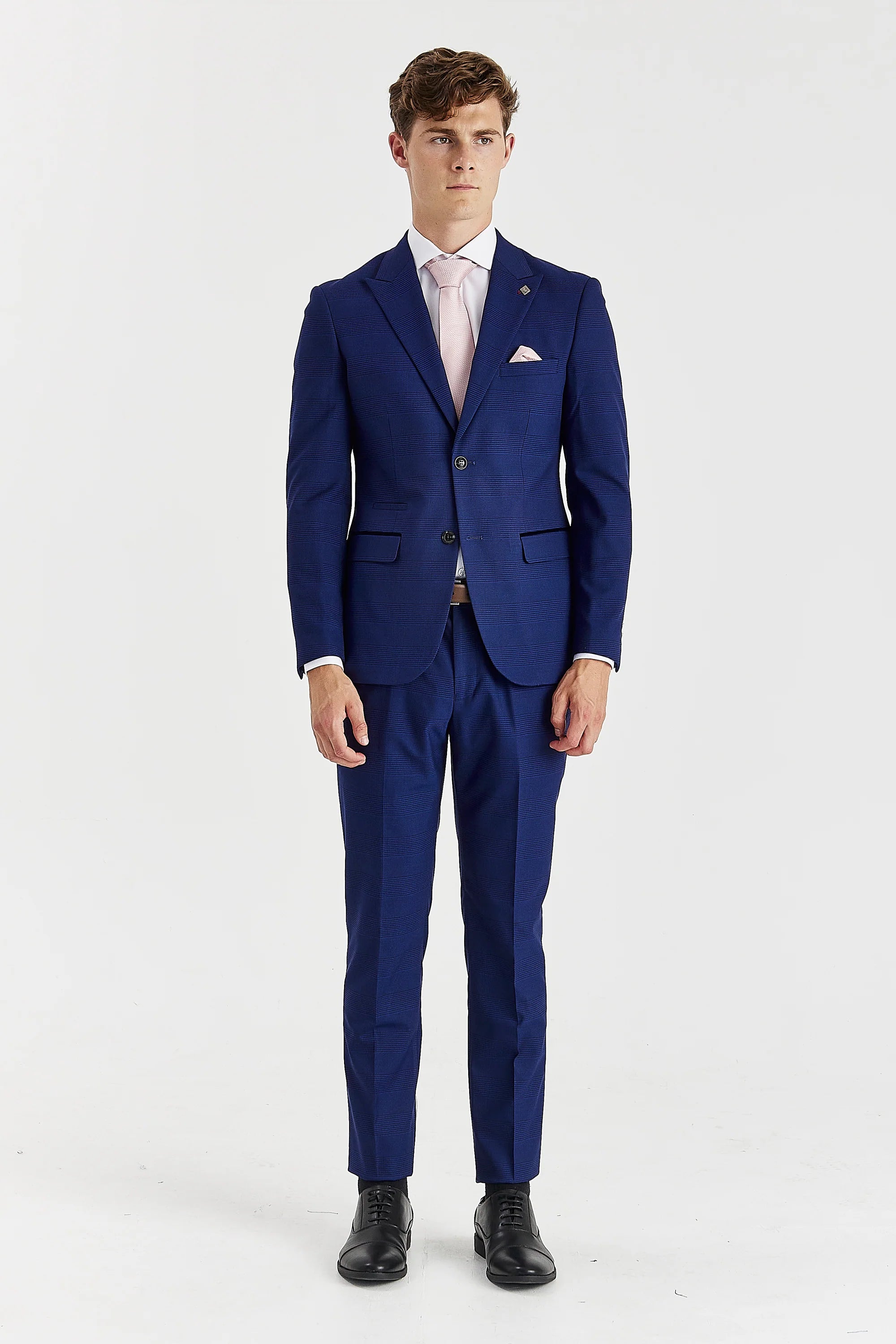 Front view of the blue check blazer, worn with matching trousers, a white shirt, light pink tie and matching pocket square.