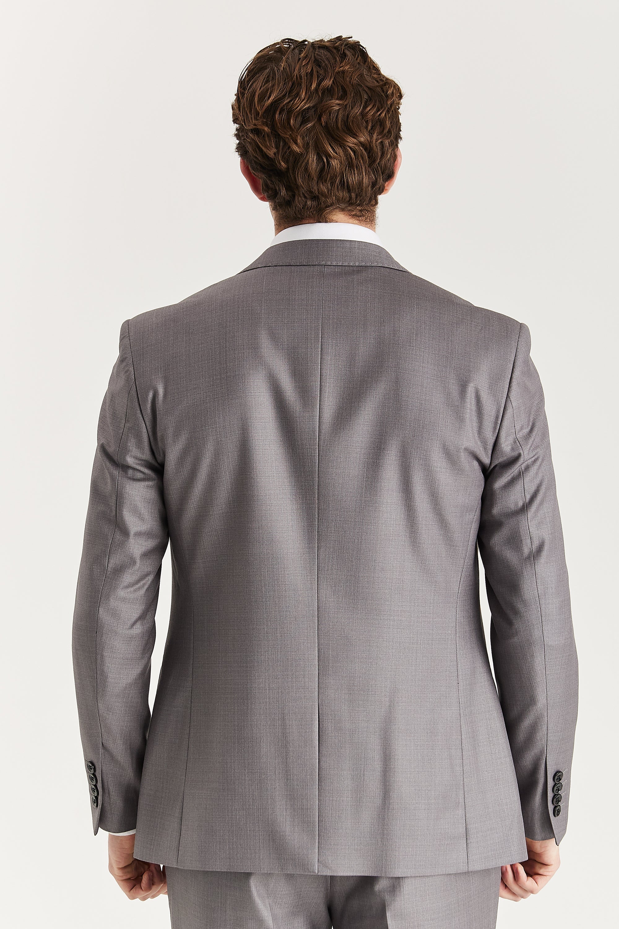 Rear view of the grey blazer with a single vent, central back seam and black sleeve buttons.