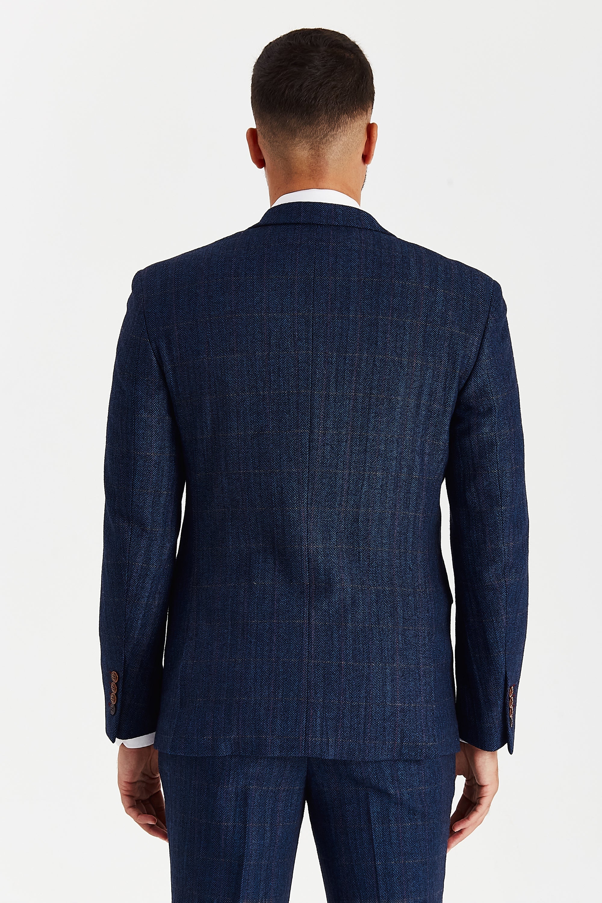 Rear view of the Scott navy tweed check blazer with the herringbone texture continuing across the back and a central back seam.