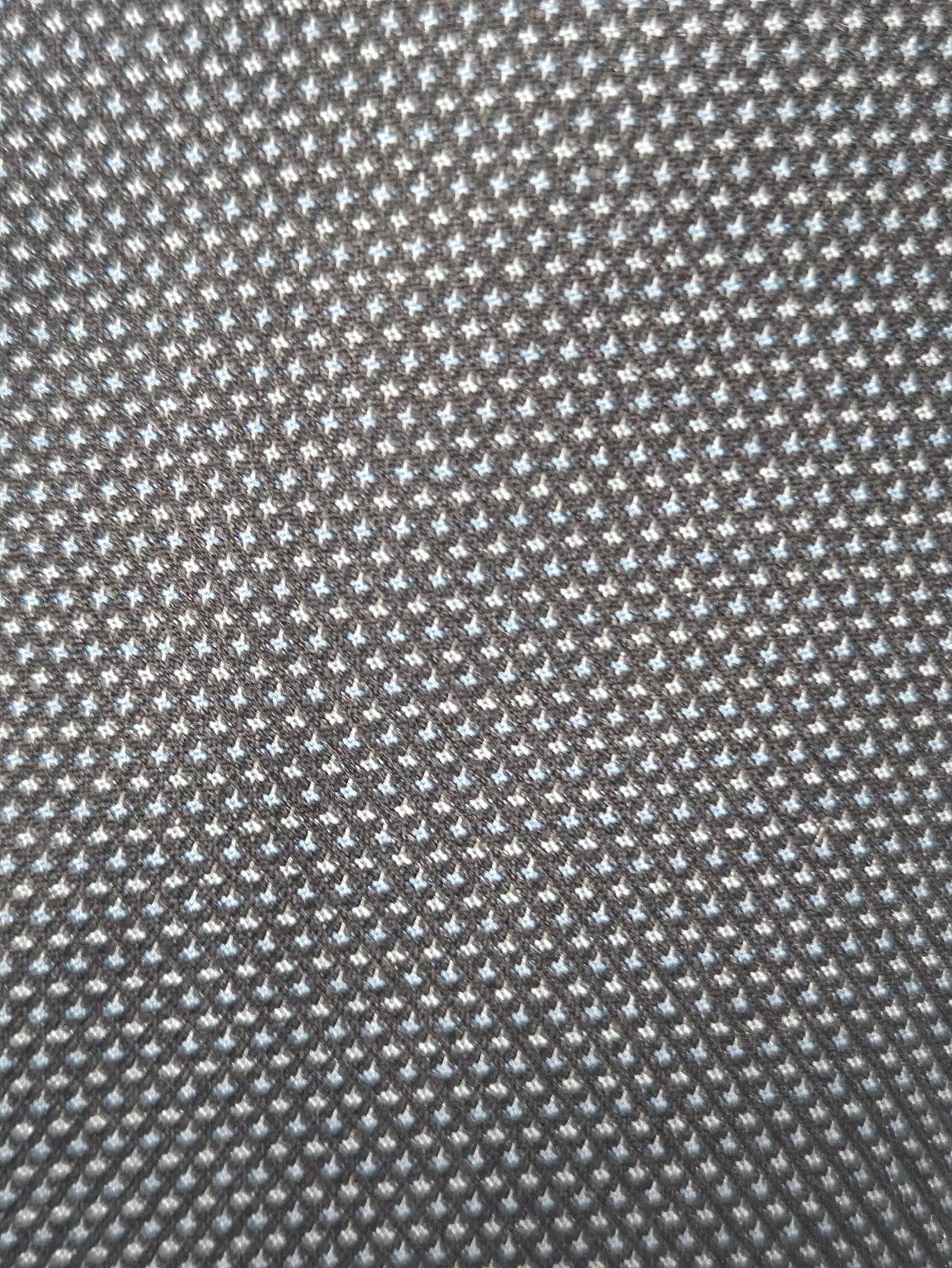 Close-up of navy birdseye weave fabric showing textured pattern in fine detail.