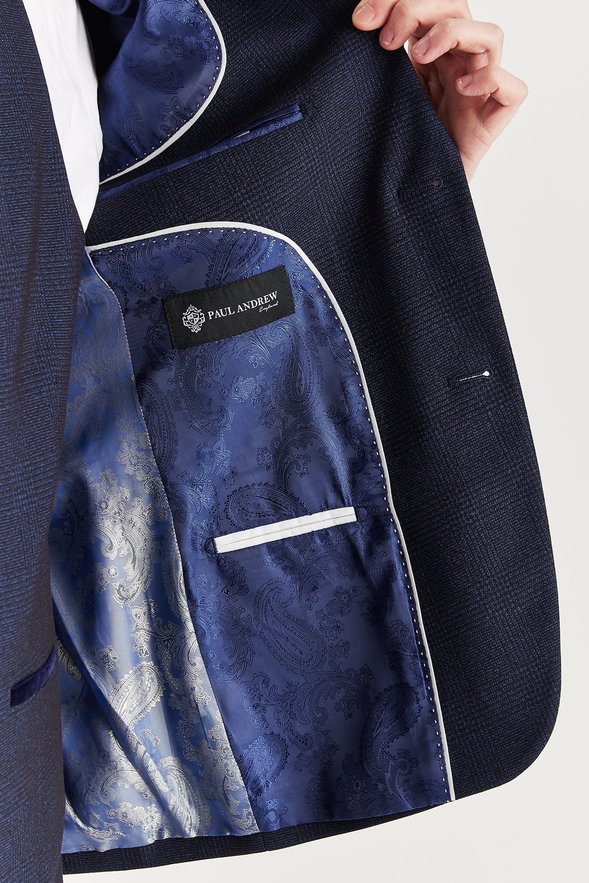 Interior view of the navy check blazer with blue and silver paisley lining and a visible Paul Andrew logo label.