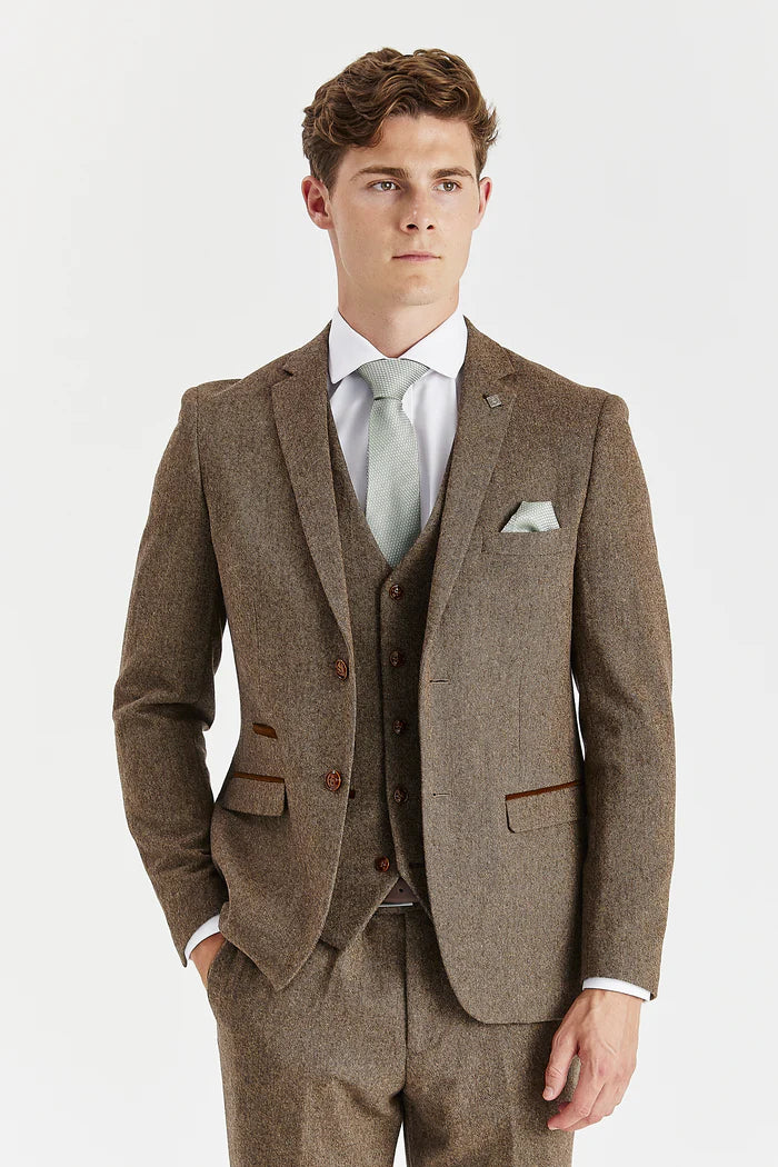 Close-up of Oscar brown tweed three-piece suit jacket showing textured fabric, brown buttons, and contrasting pocket trim.