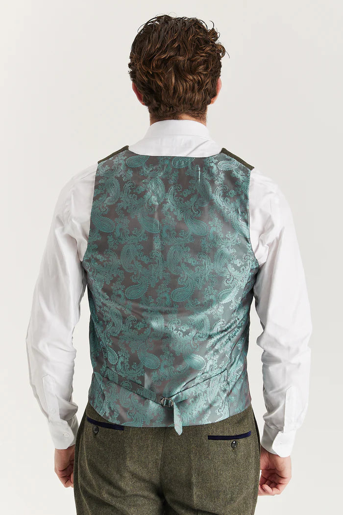 Back view of Oscar green tweed waistcoat featuring teal paisley satin fabric and adjustable belt detail.