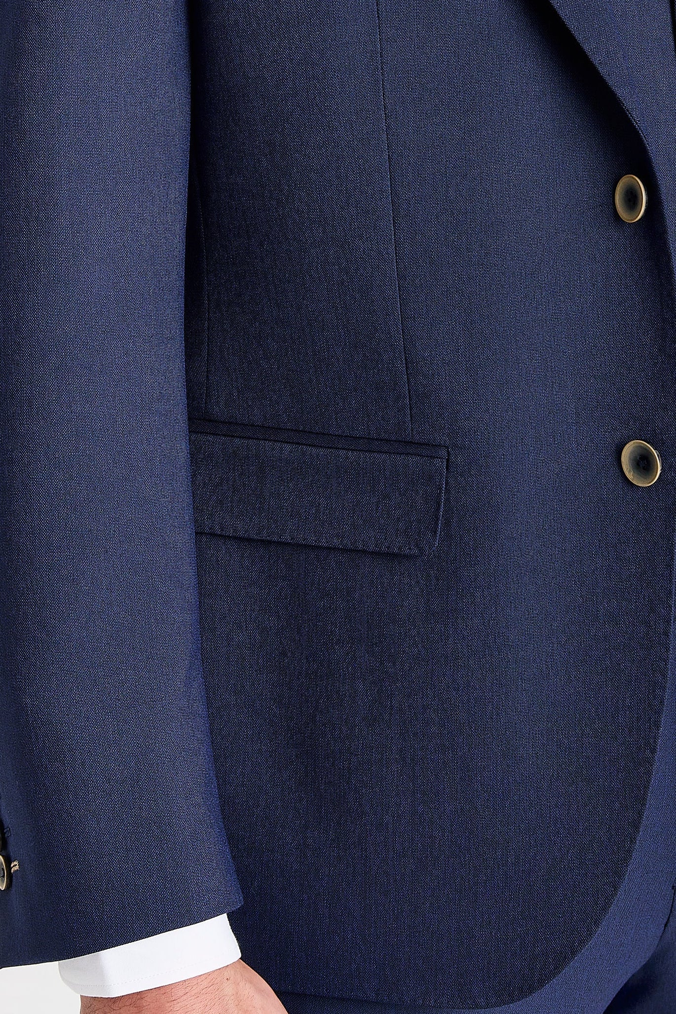 Close-up detail of a Belmont navy suit jacket and waistcoat showing smooth fabric, flap pocket and cream buttons.