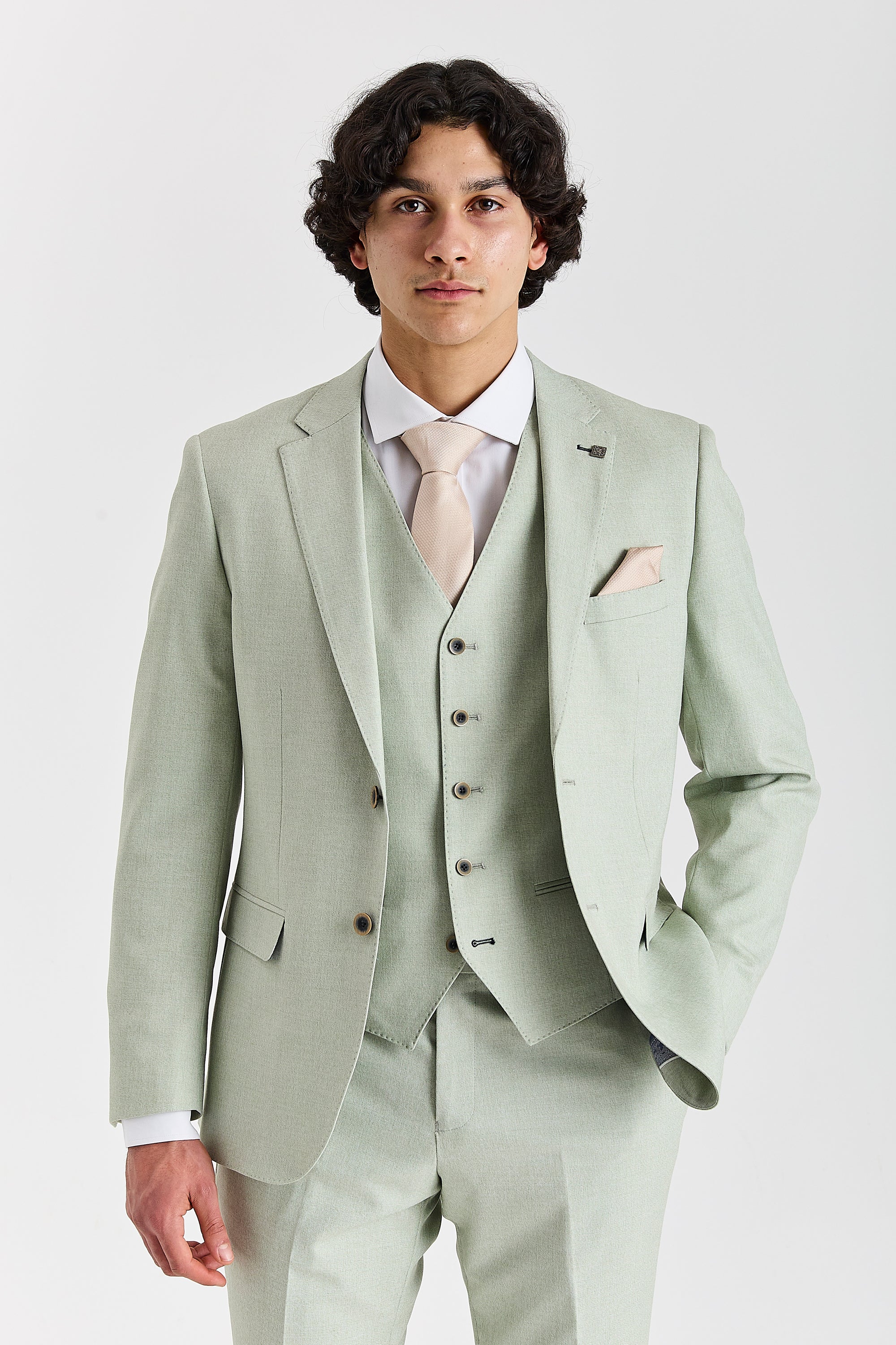 Front view of a man wearing a mint green three piece suit with a cream tie, matching waistcoat and cream pocket square.
