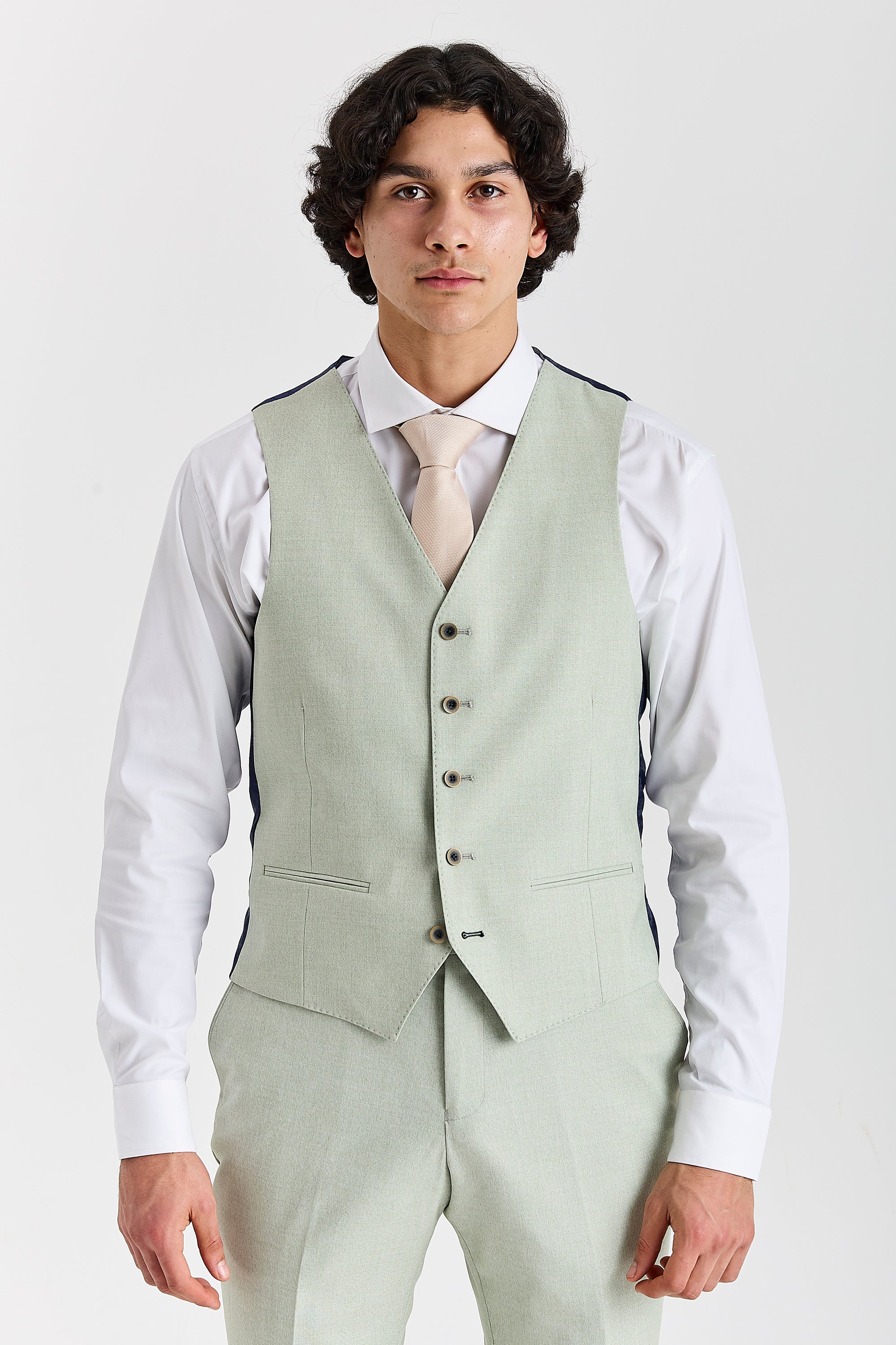 Front view of a mint green waistcoat with cream tie, white shirt, matching trousers and contrast buttons.