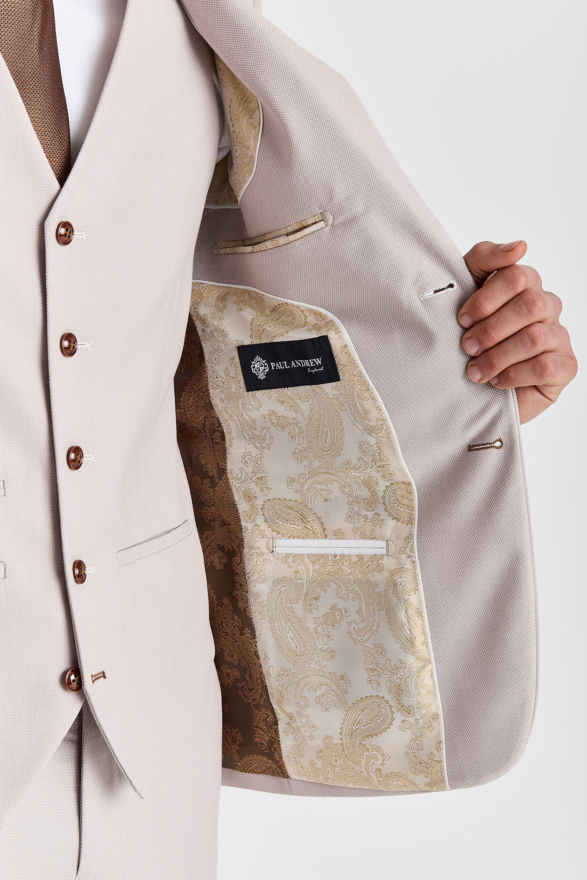 Interior view of the Mayfair stone textured blazer with brown and cream paisley lining and a visible Paul Andrew logo label.