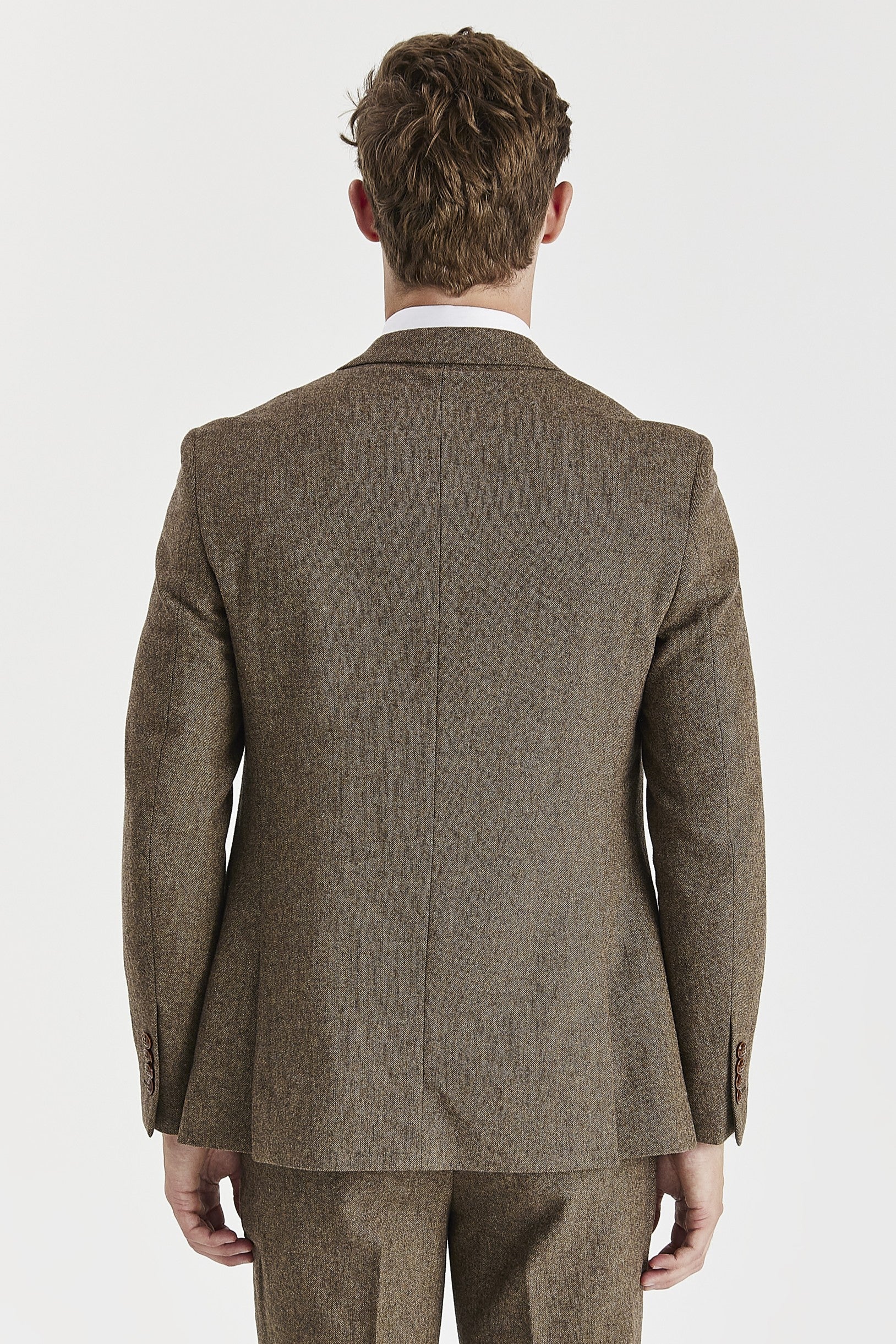 Rear view of the brown tweed blazer with a ventless back, central back seam and brown sleeve buttons.