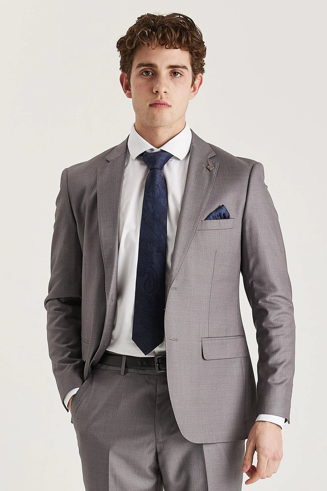 Front blazer view of grey suit jacket worn with a white shirt, navy tie and pocket square