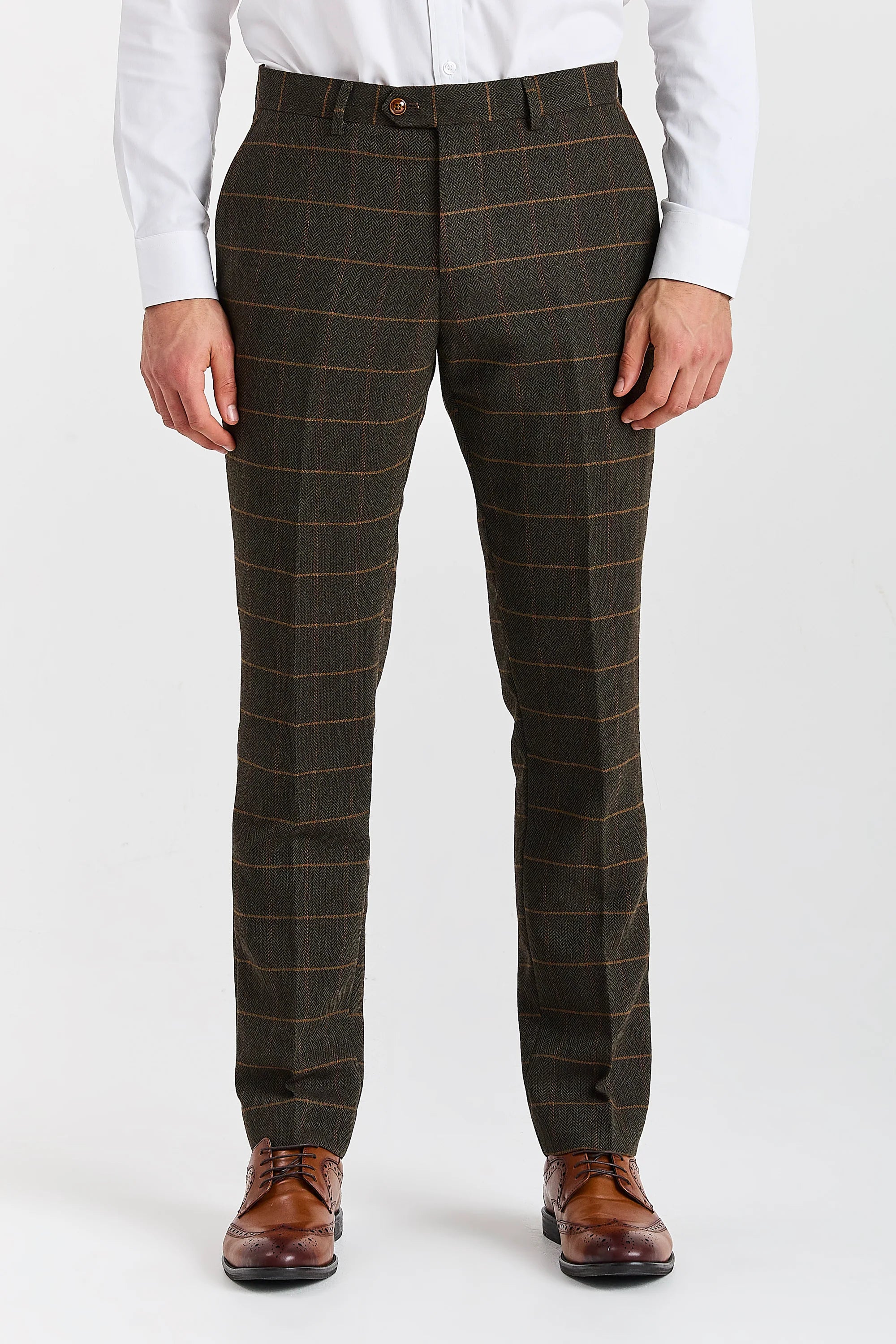 Front view of Harris green herringbone tweed trousers with a tan windowpane check, worn with a white shirt and brown brogue shoes.