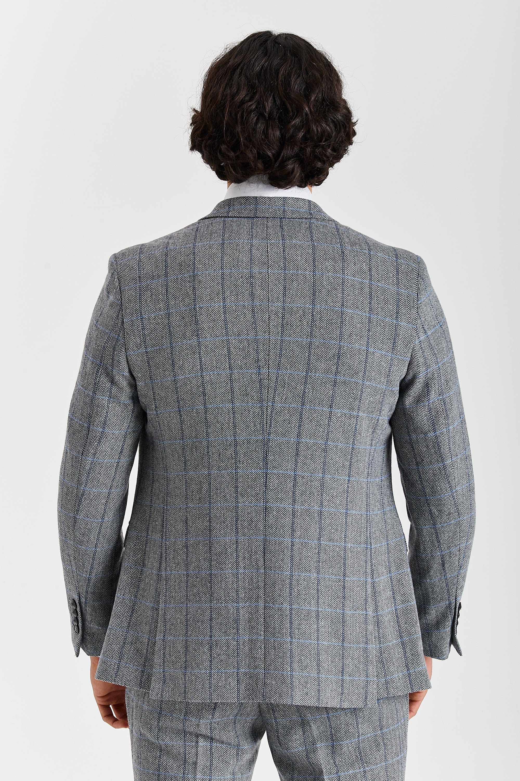 Back view of a Harris grey herringbone tweed check suit jacket with matching trousers and black sleeve buttons.
