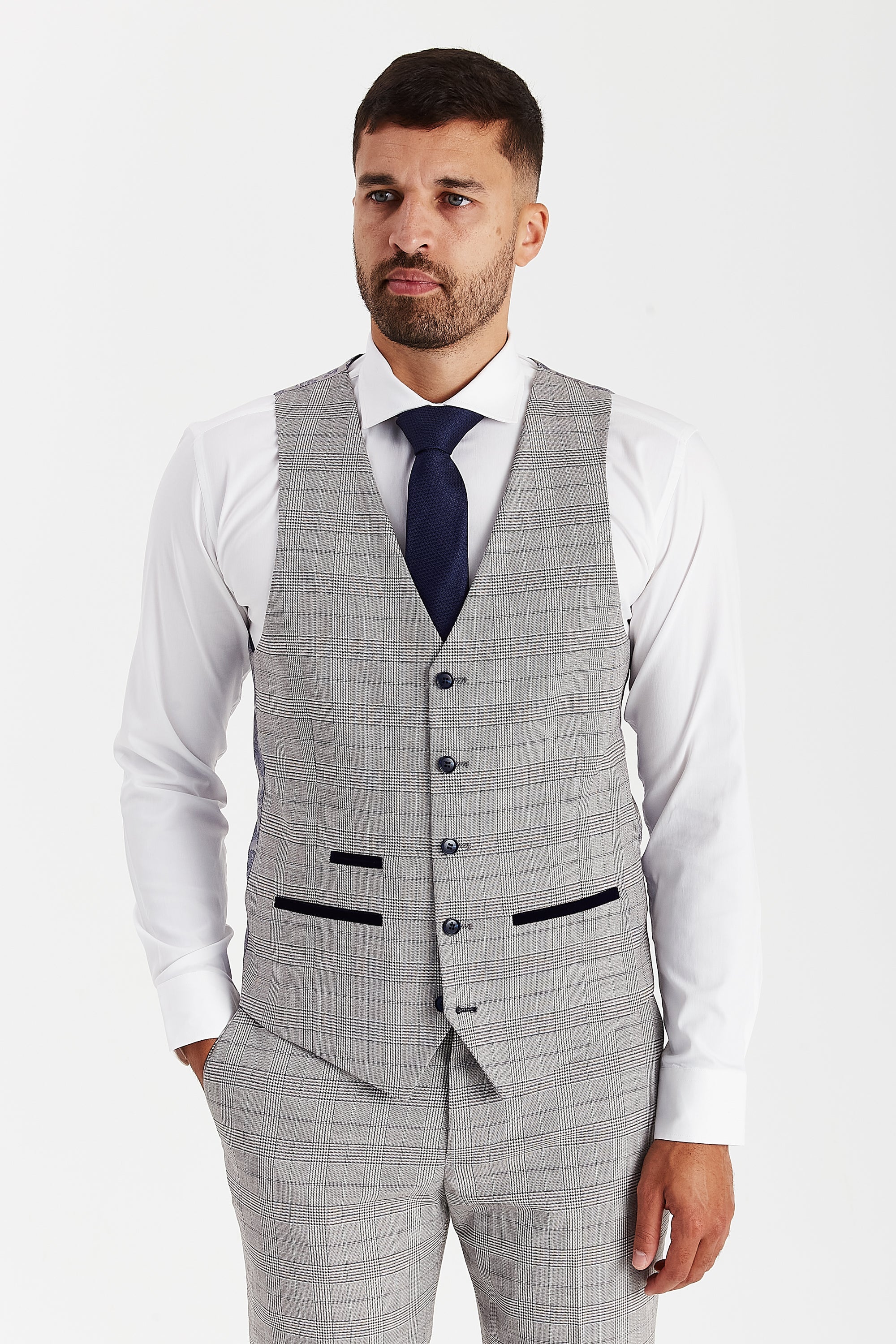 Front view of a grey waistcoat with a glen check pattern, matching trousers, white shirt and navy tie.