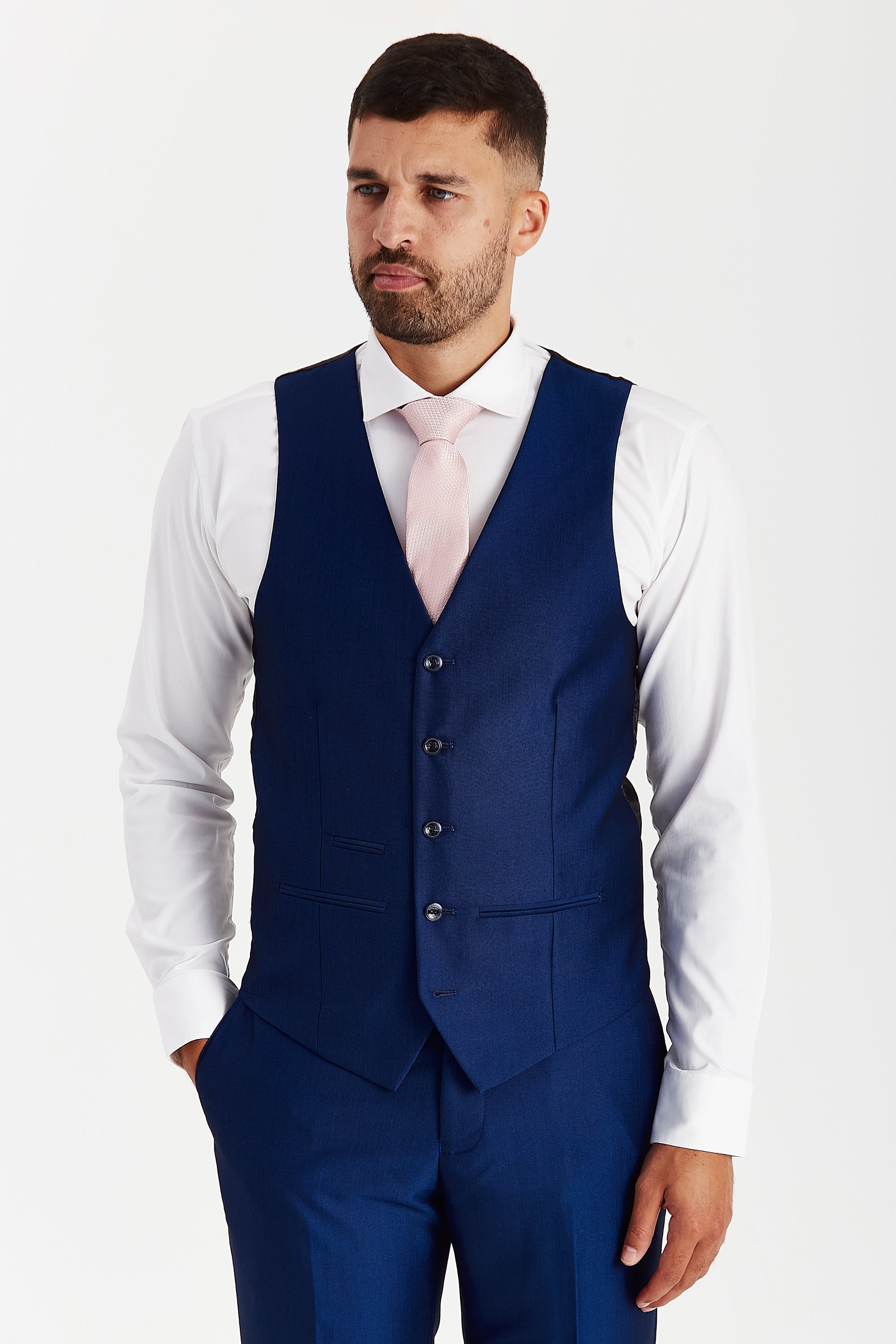 Front view of a blue waistcoat with matching trousers, a white shirt and a pink tie.