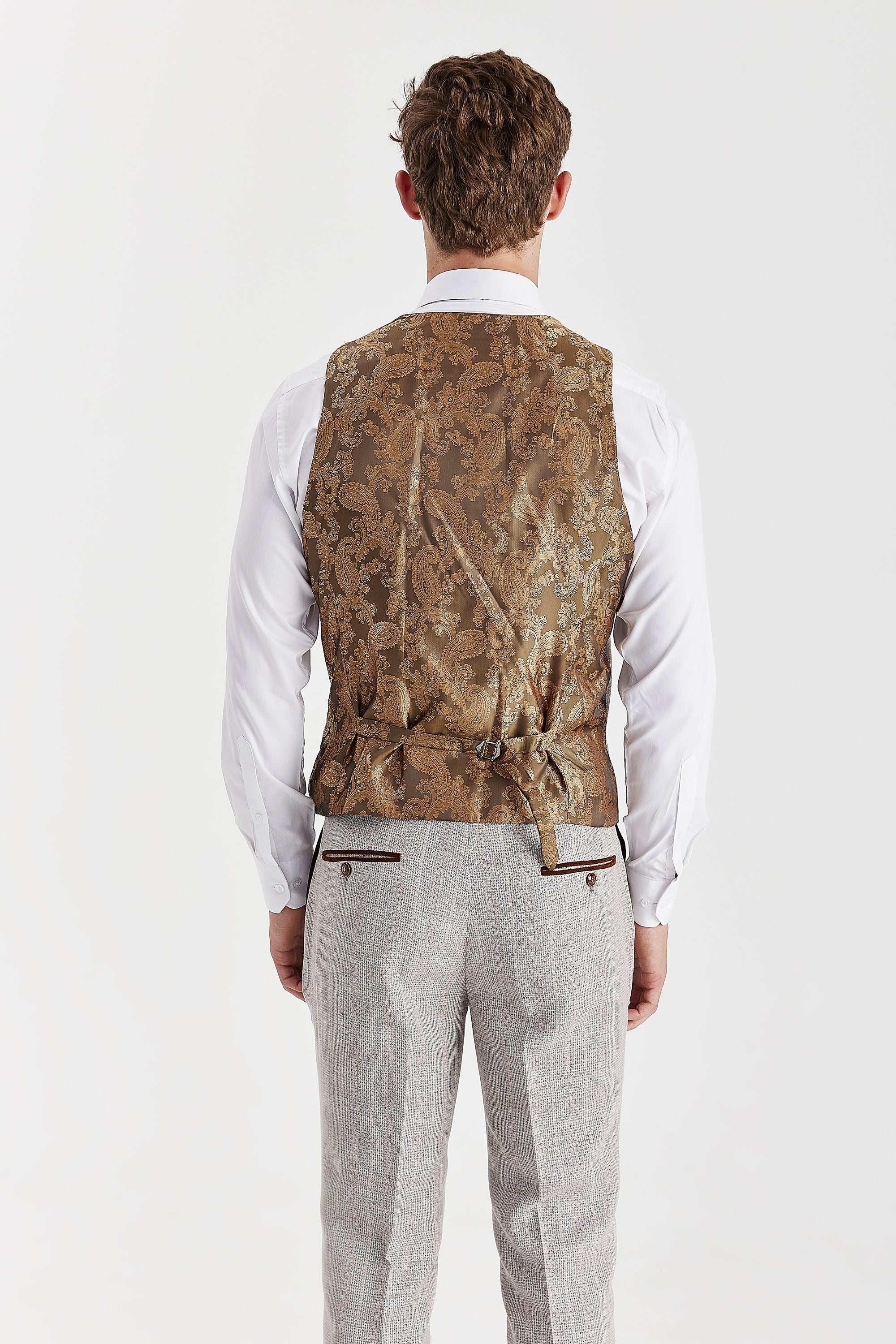 Back view of a beige suit with a brown paisley waistcoat back panel and an adjustable strap.