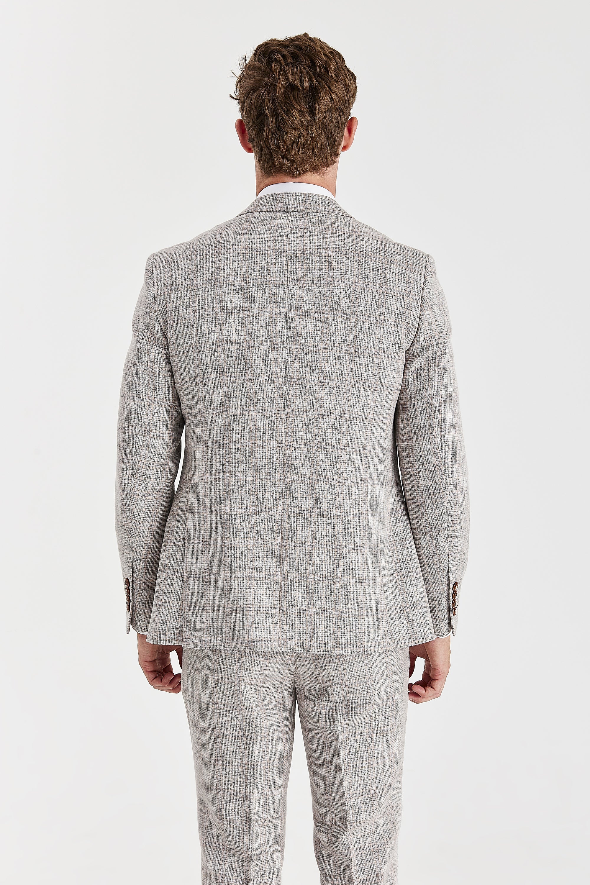 Back view of a beige check suit jacket with matching trousers.