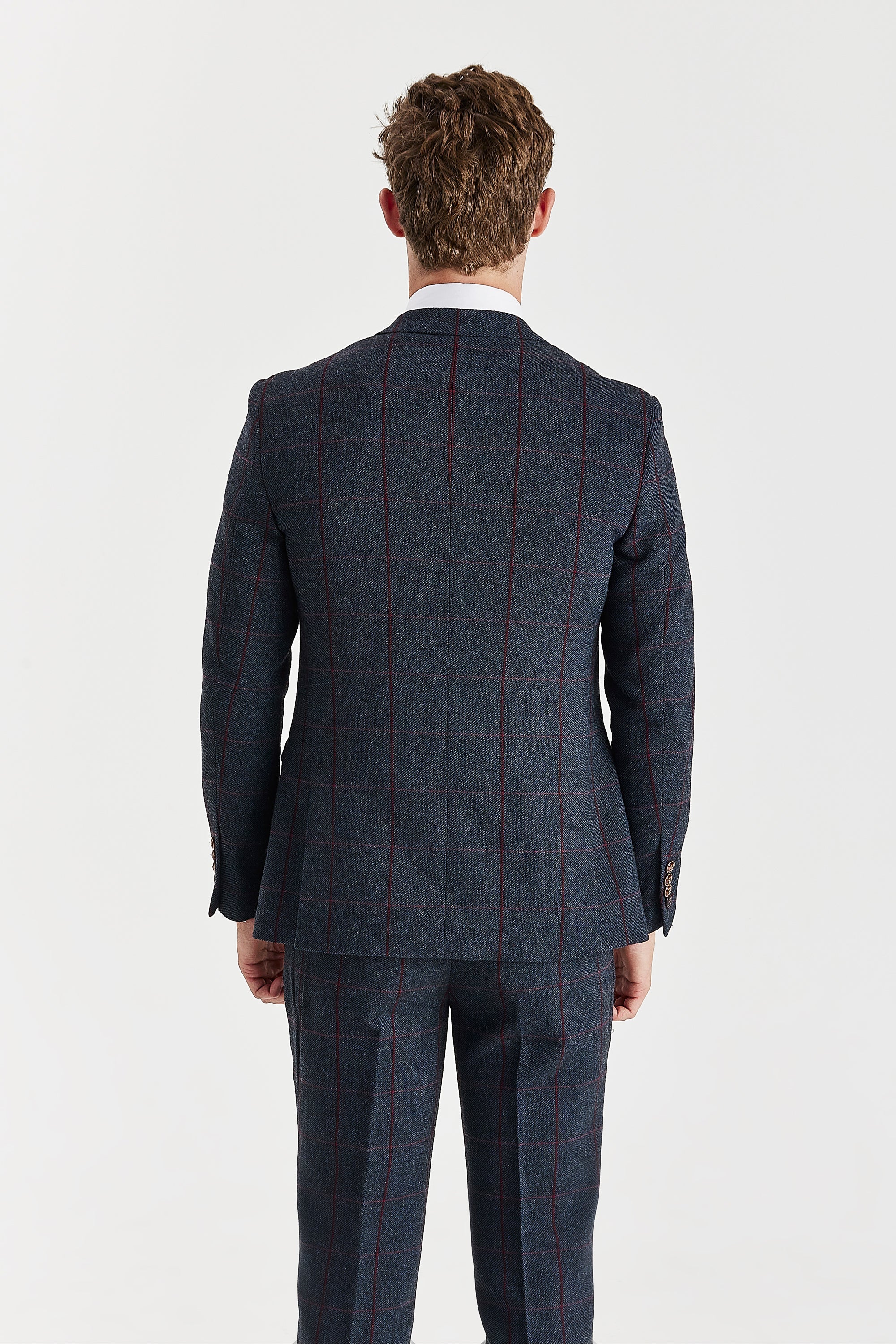 Back view of a navy tweed suit jacket with a burgundy windowpane check pattern and matching trousers.