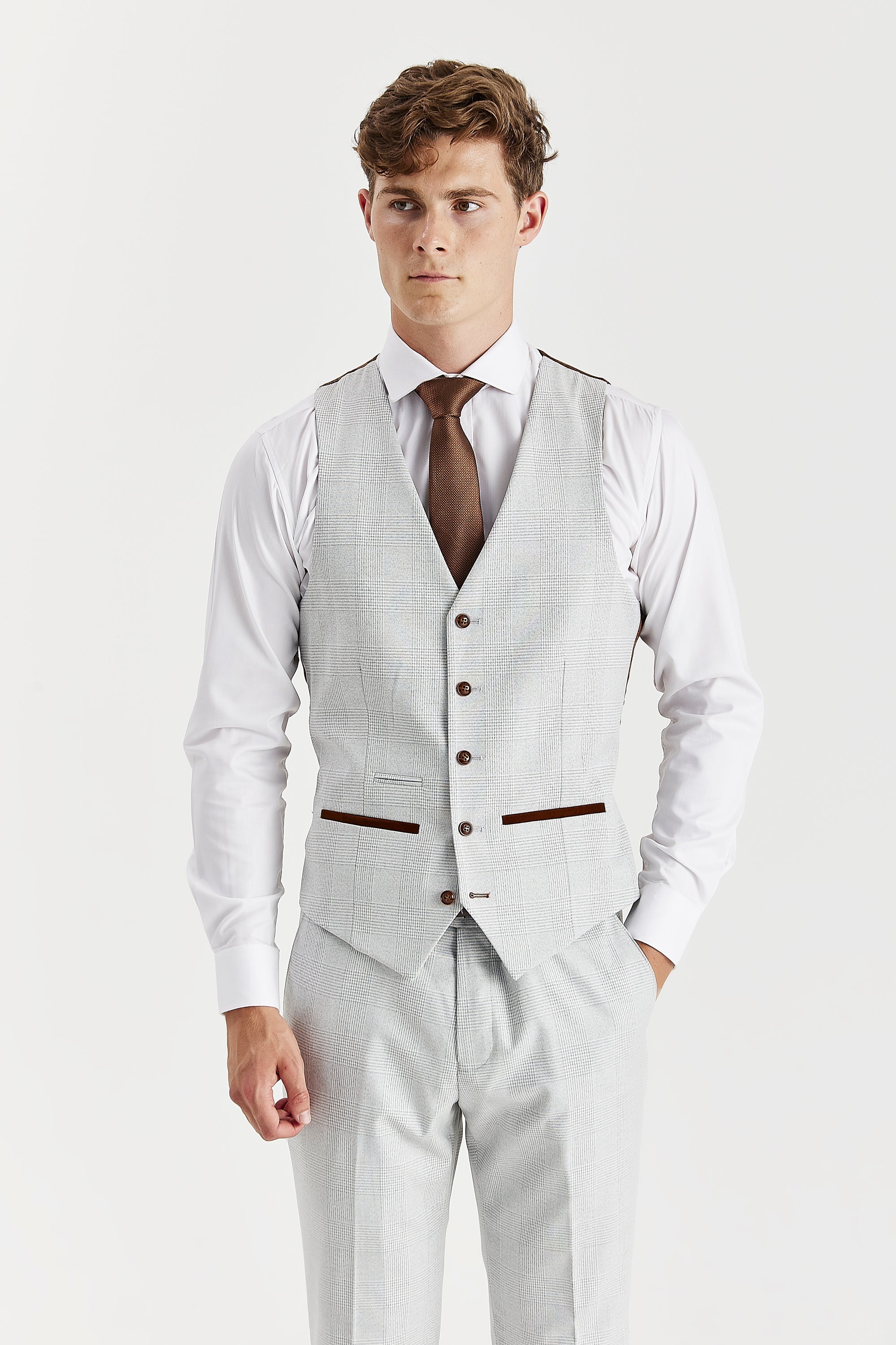 Front view of a stone waistcoat with a glen check pattern, matching trousers, a white shirt and a brown tie.