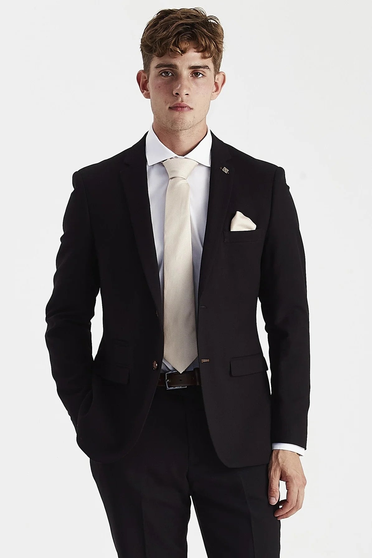 Front blazer view of black textured suit jacket worn with a white shirt, cream tie and pocket square