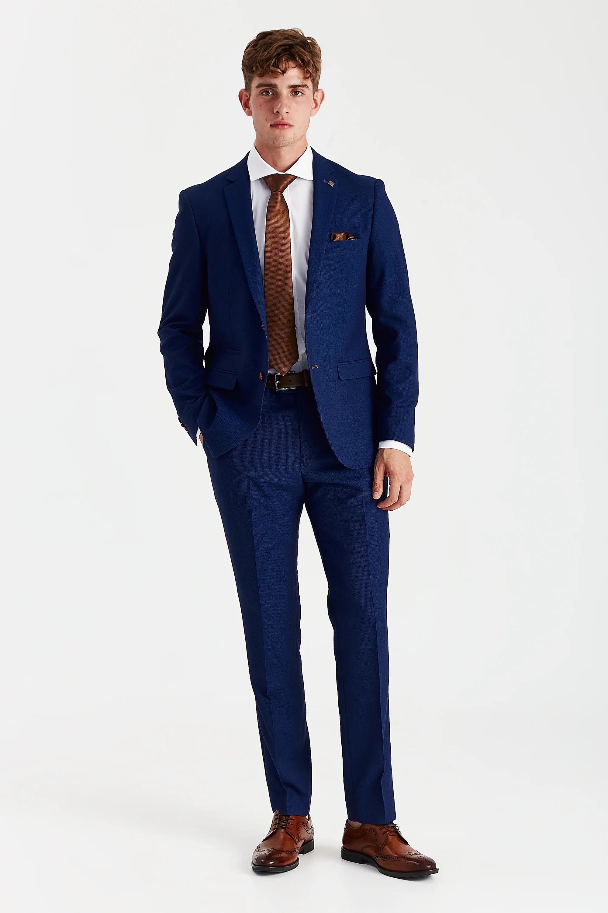 Full front view of blue textured two-piece suit worn with a white shirt, brown tie and brown brogues