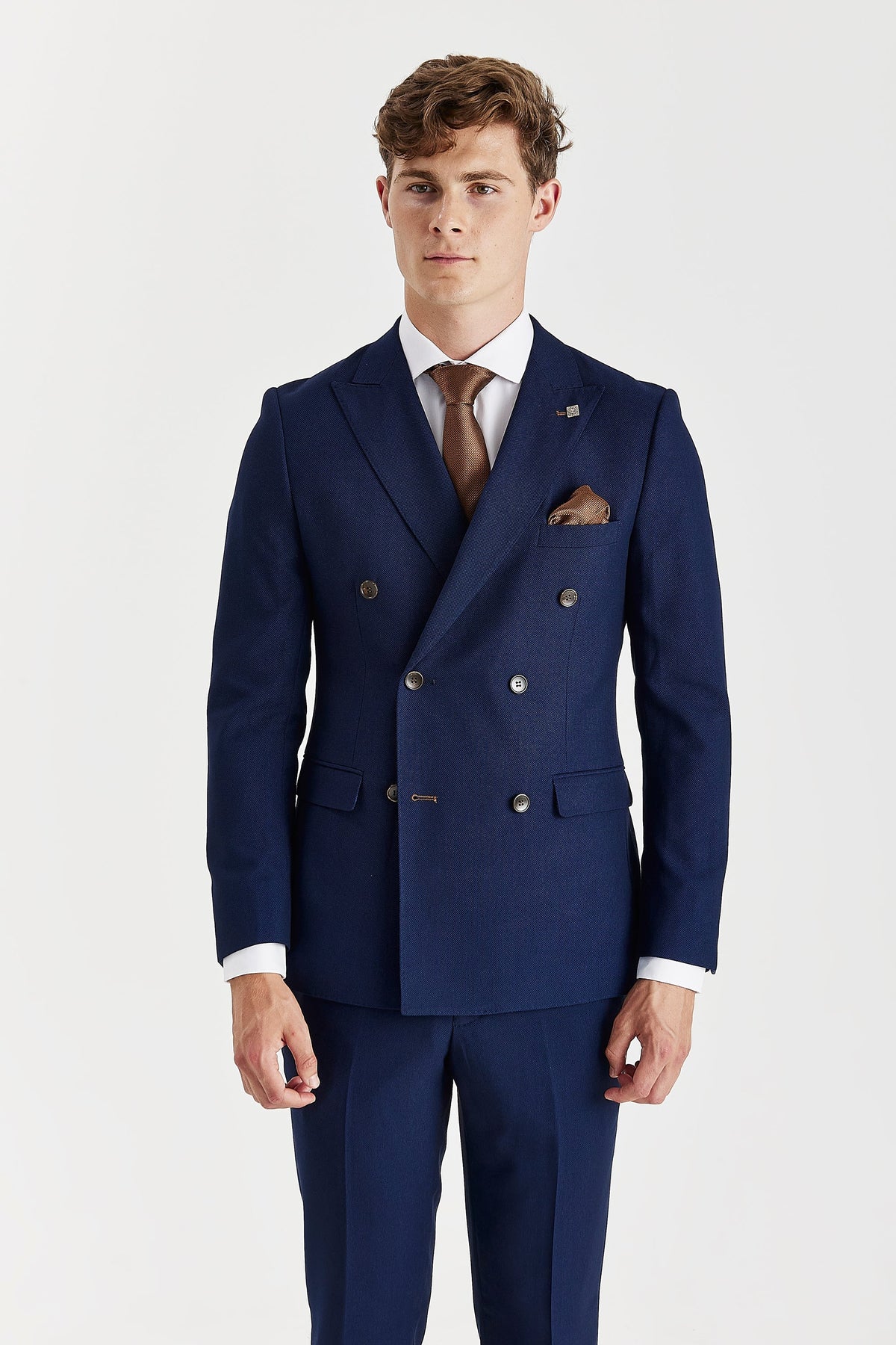 Front view of the navy double-breasted jacket showing peak lapels, six brown buttons and flap pockets.