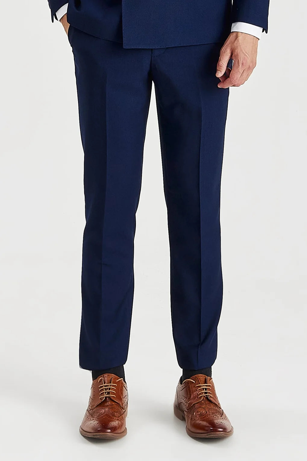 Front view of the navy trousers showing the flat front, pressed creases and tapered legs.