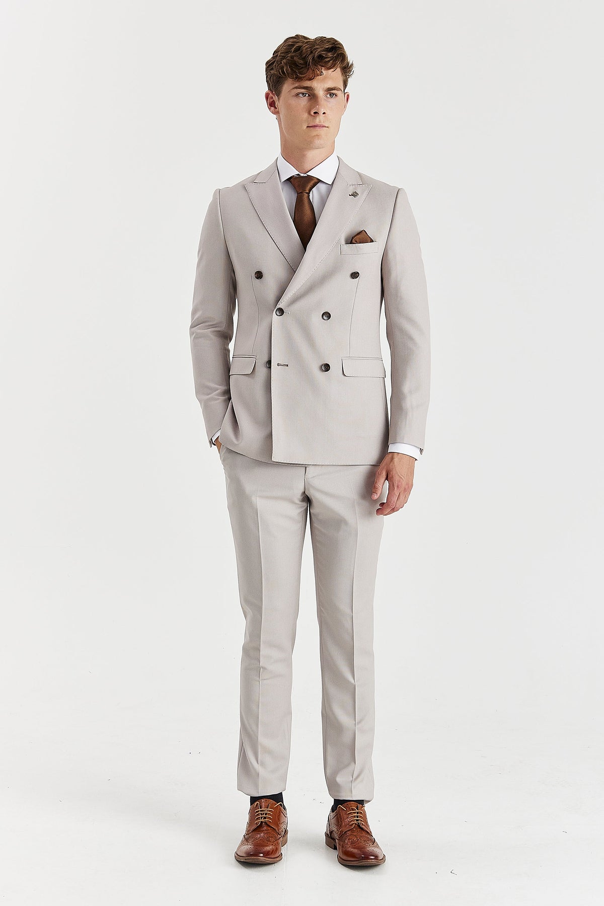 Full-length front view showing the stone jacket’s shaped waist and matching trousers with pressed creases.