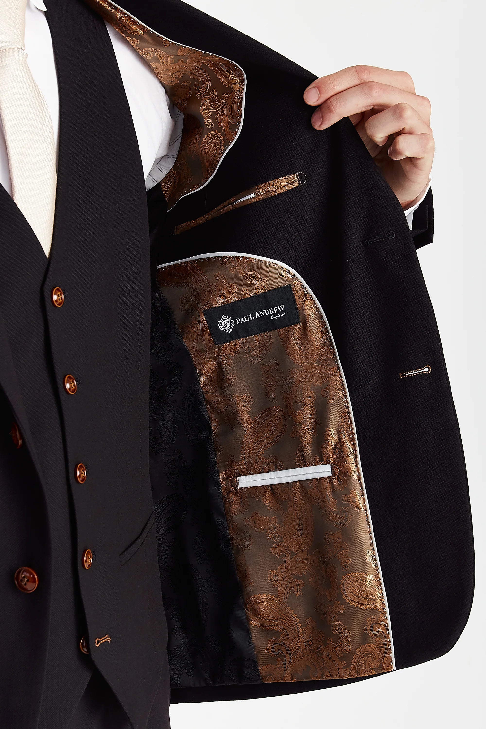 Interior view of the black textured  blazer with black and brown paisley lining and a visible Paul Andrew logo label.